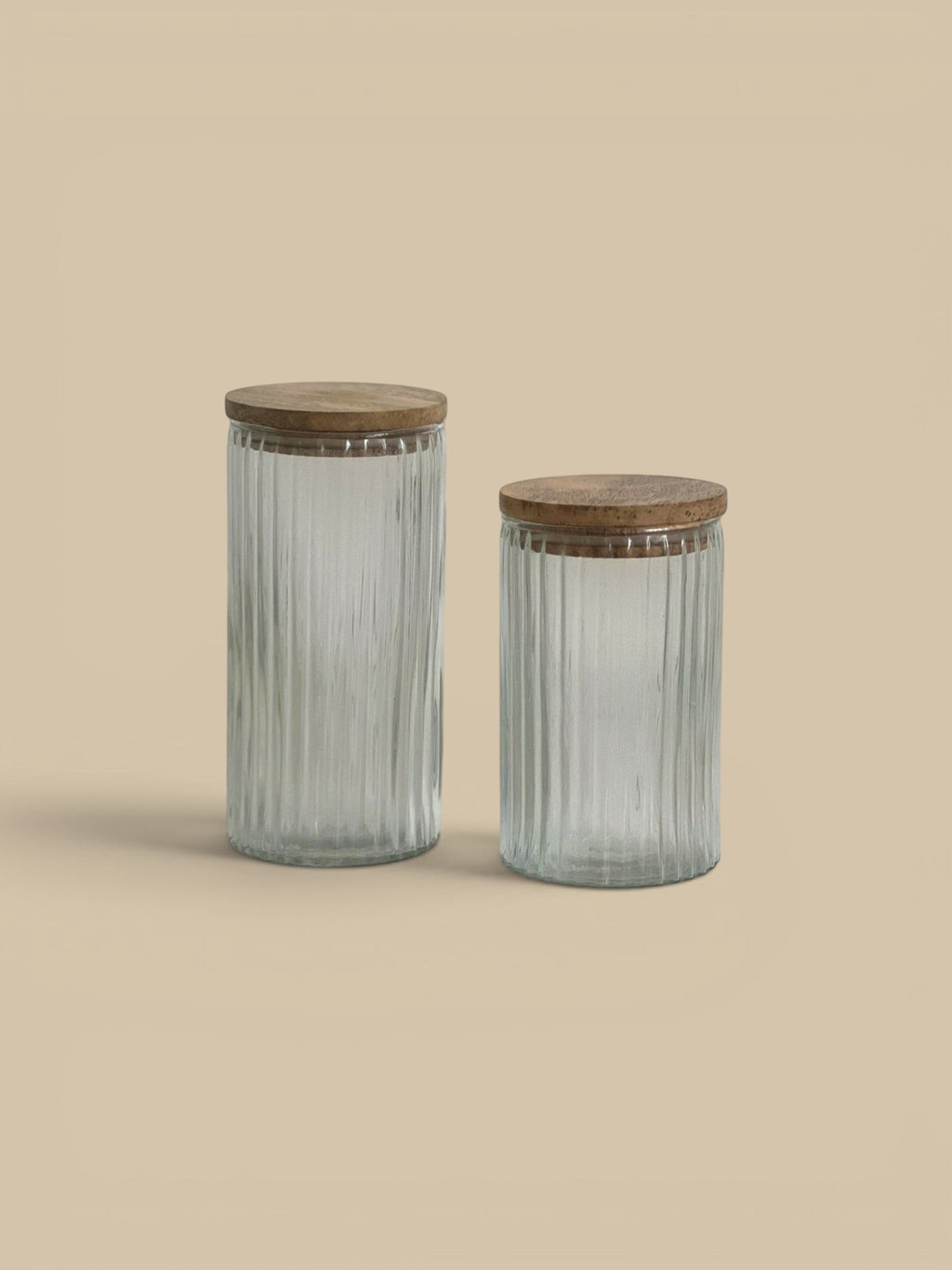 Homestyle Collective Clara ribbed glass canisters with wooden lids, available in two sizes for pantry or bath storage.
