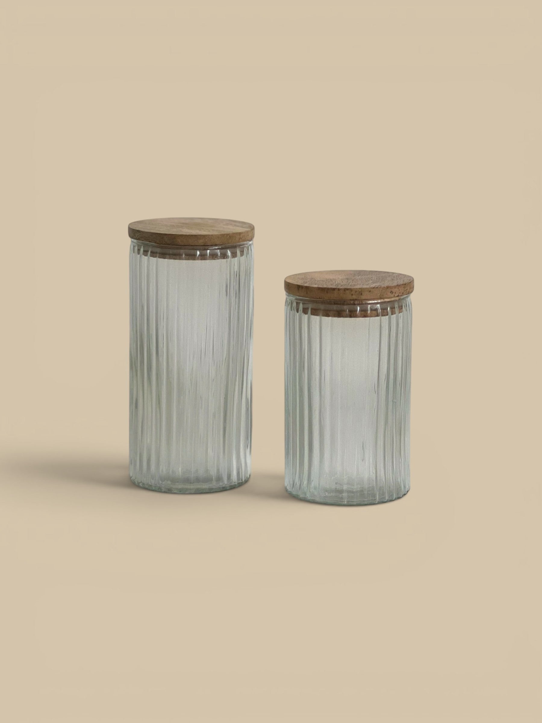 Homestyle Collective Clara ribbed glass canisters with wooden lids, available in two sizes for pantry or bath storage.