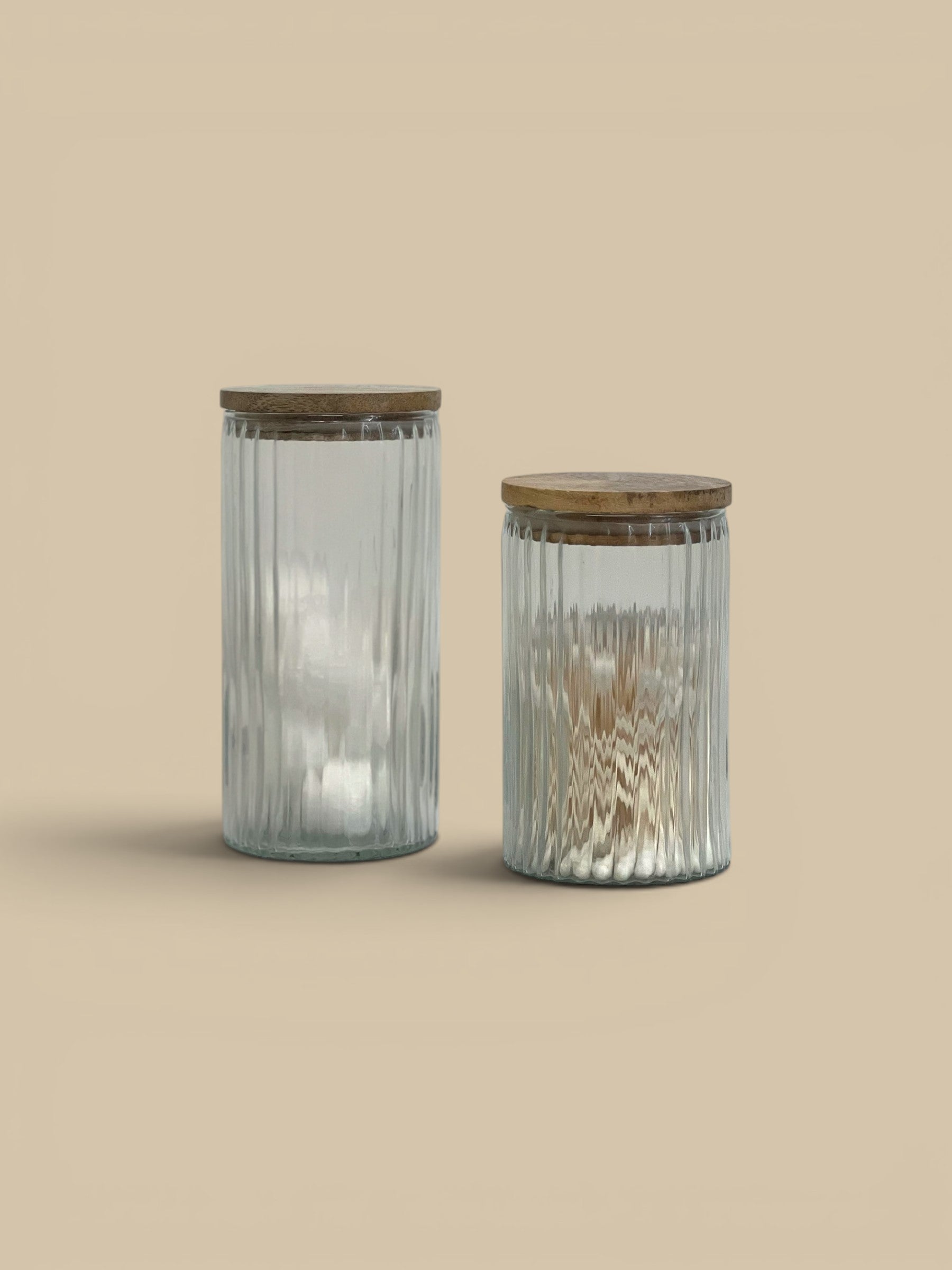 Homestyle Collective Clara ribbed glass canister with wooden lid, available in two sizes for pantry or bath storage.