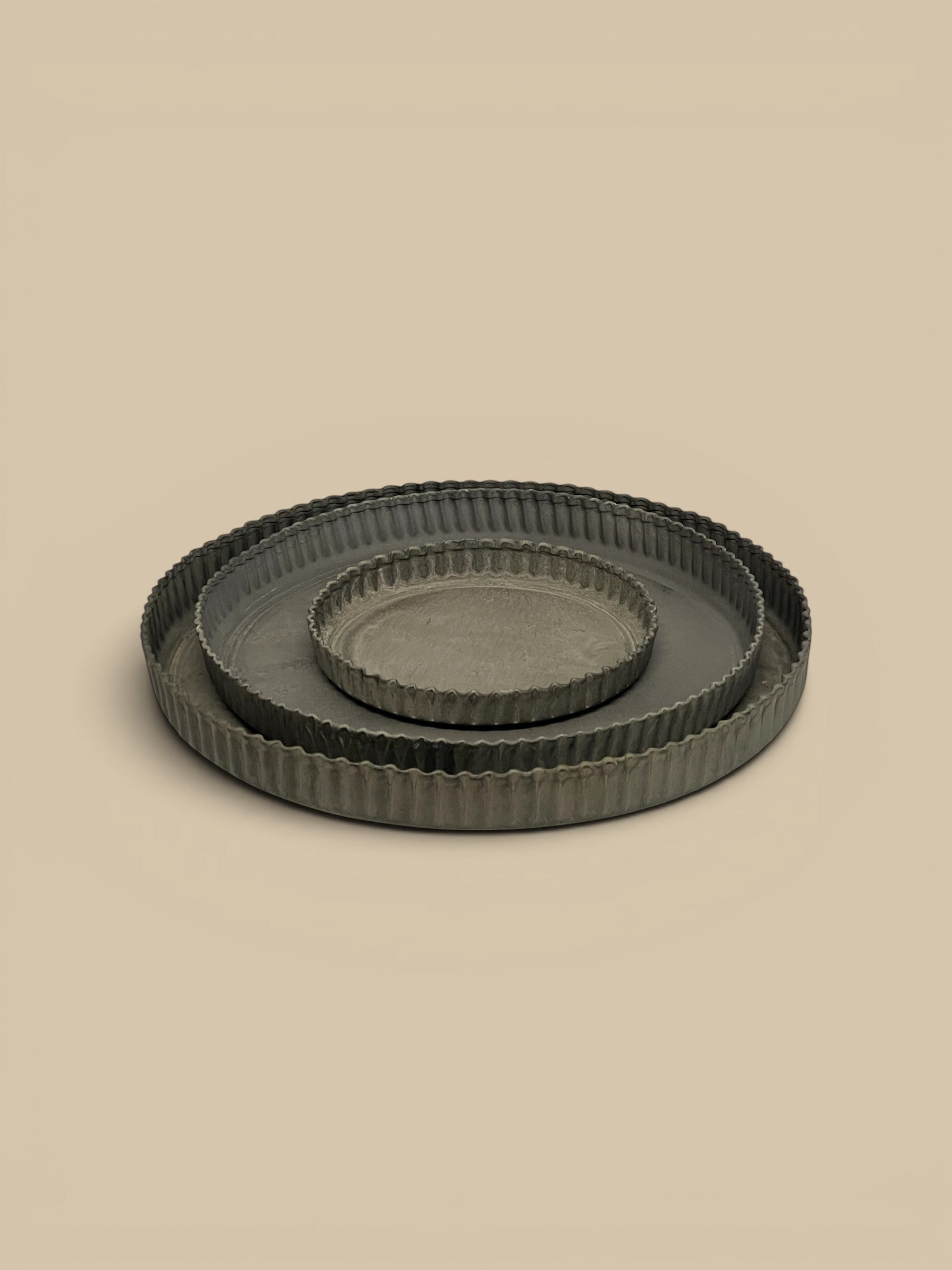 Homestyle Collective Ross Tray set of 3 dark grey metal tart dishes with crimped edges for styling.