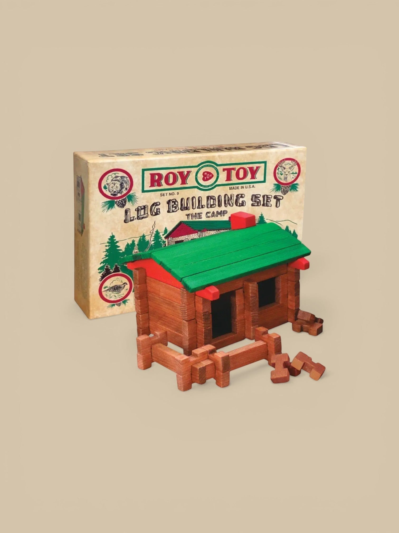 Homestyle Collective Roy Toy 1930's Log Building Set, wooden cabin toy with green roof and red accents, includes fence pieces.