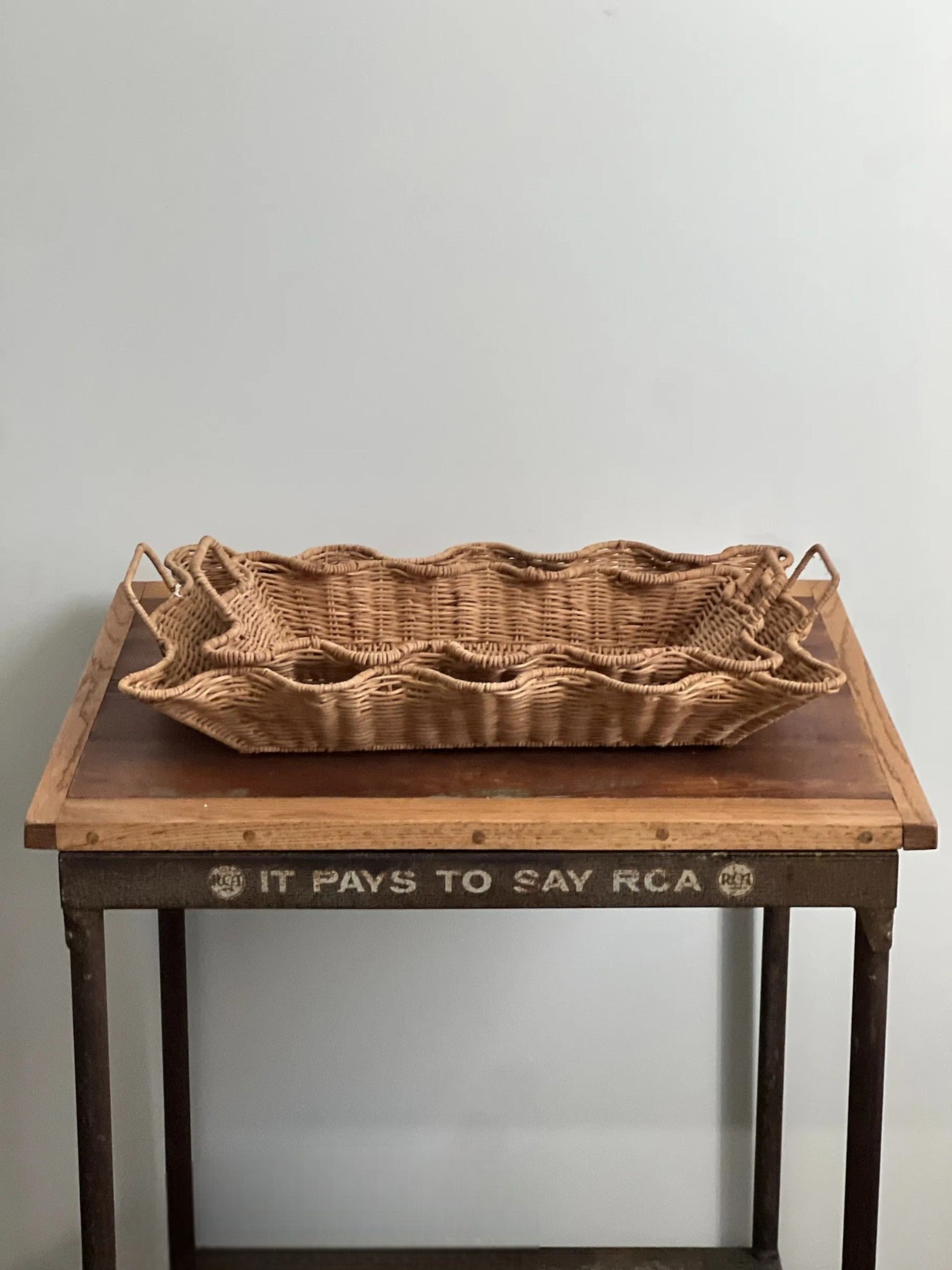 Homestyle Collective set of 2 scalloped edge natural rattan nesting trays with handles. Perfect for serving or decor.