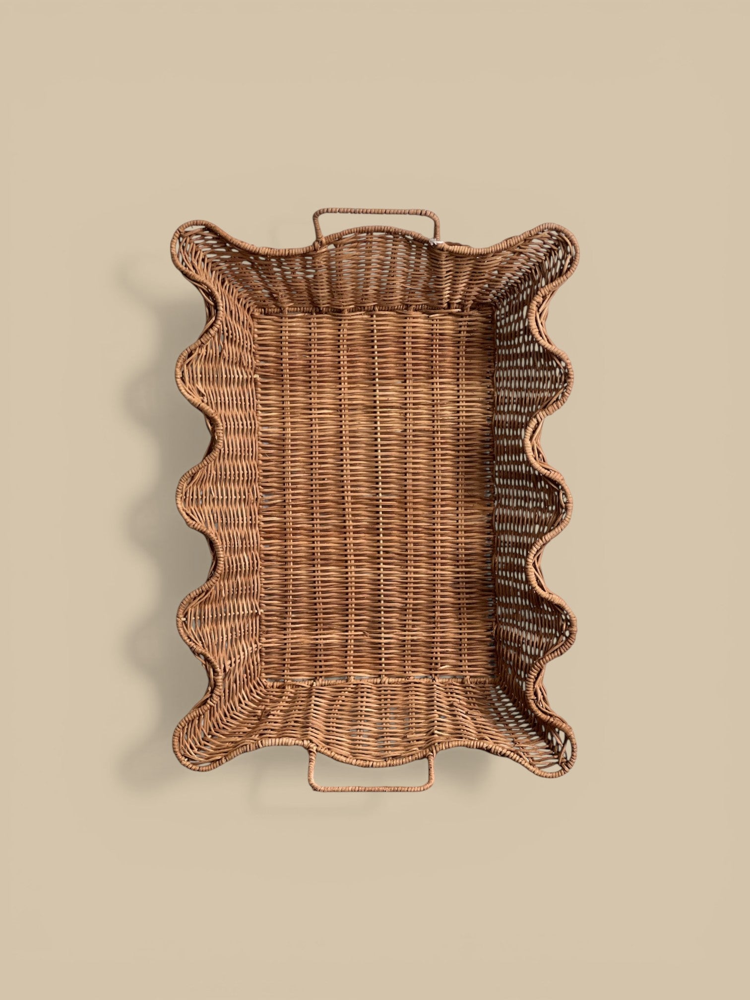 Homestyle Collective scalloped nesting rattan tray set with handles, natural finish. Set of 2.