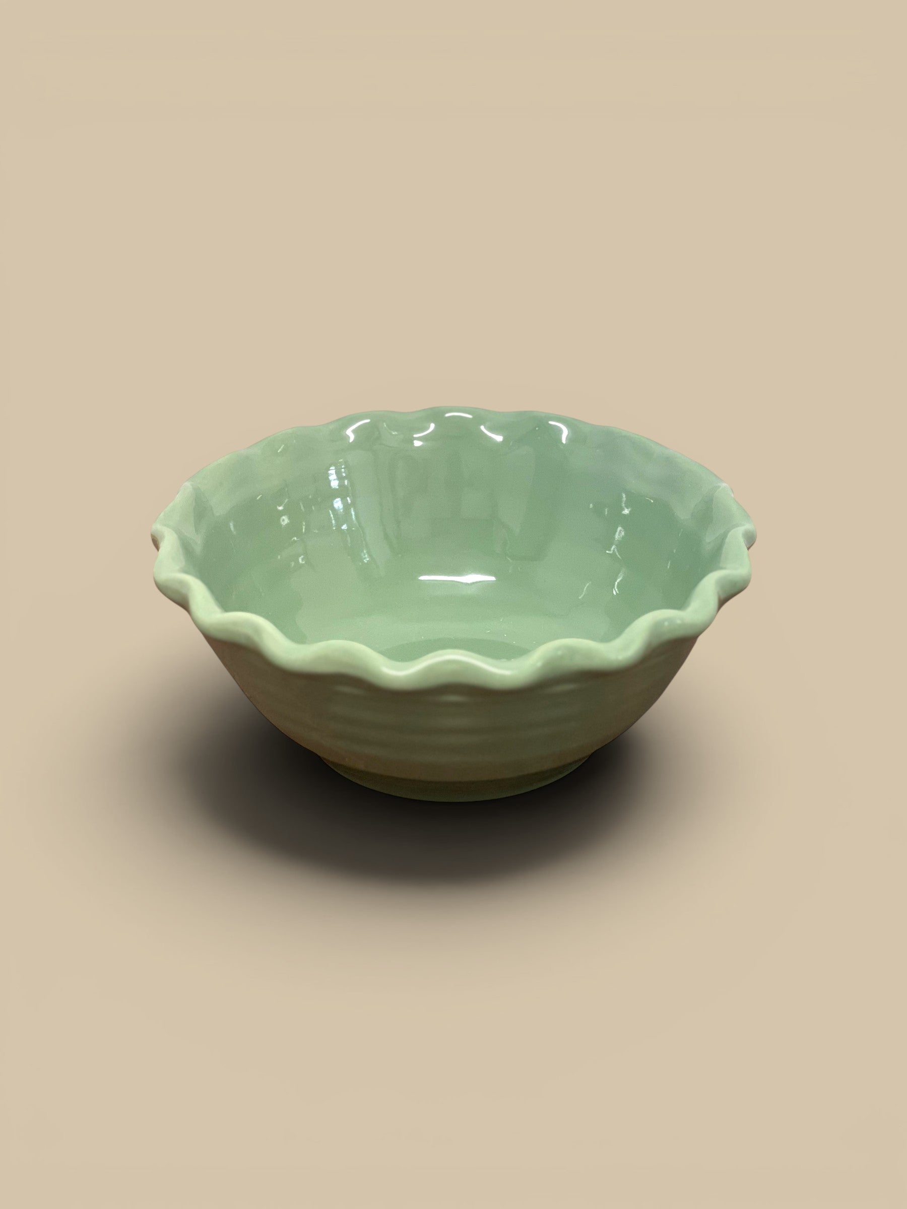 Homestyle Collective light green scalloped stoneware serving bowl with ruffled edges and a glazed finish.