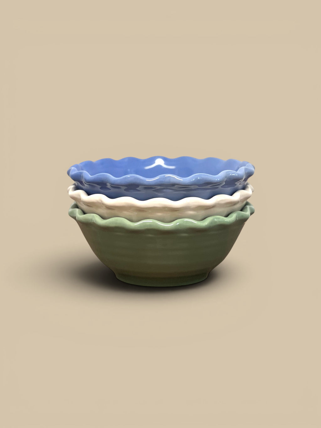 Homestyle Collective scalloped stoneware serving bowls in blue, cream, and green. Ruffled edges and glazed finish.
