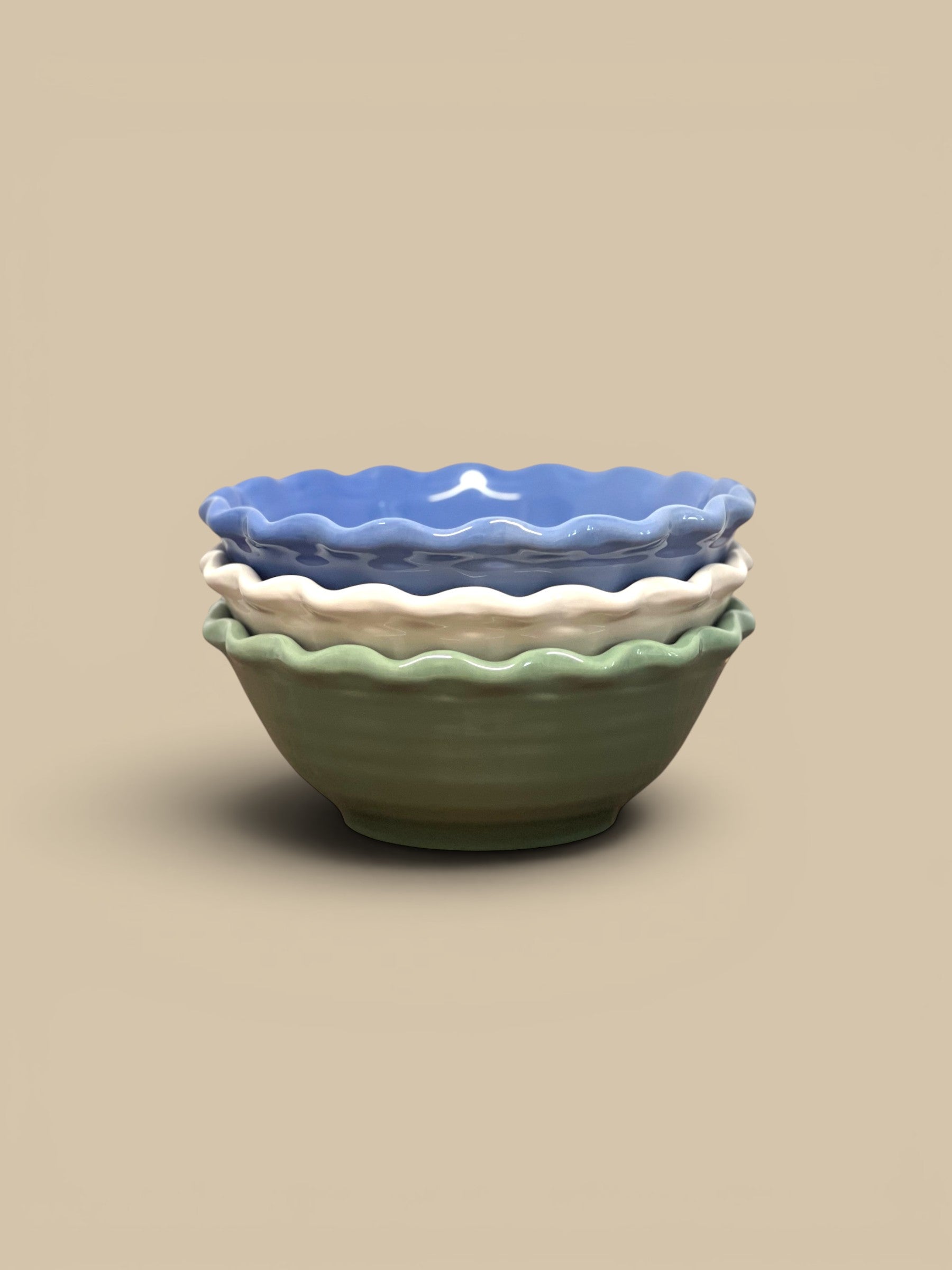 Homestyle Collective scalloped stoneware serving bowls in blue, cream, and green. Ruffled edges and glazed finish.