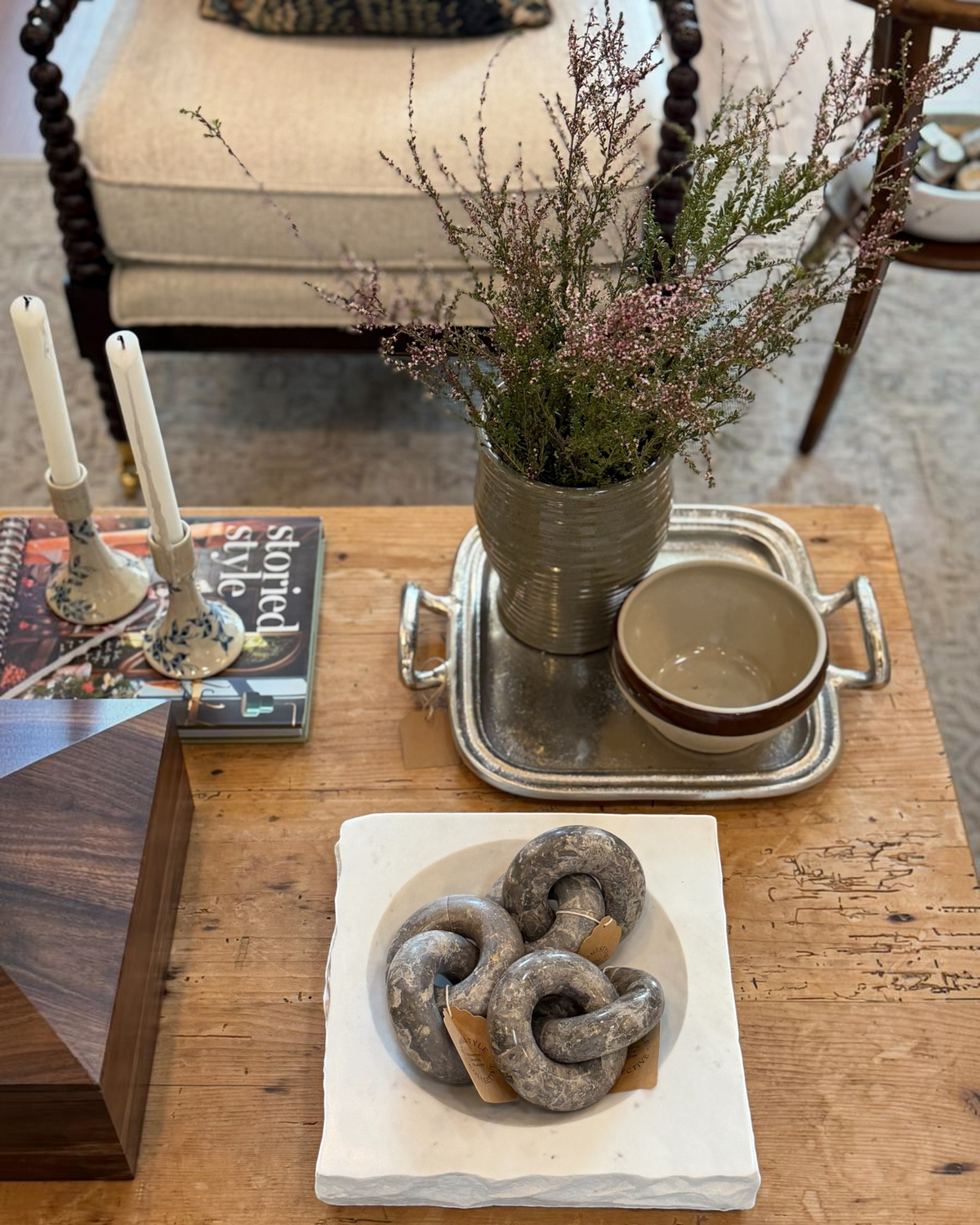Homestyle Collective silver metal hotel tray with handles styled on a wooden coffee table with decor items