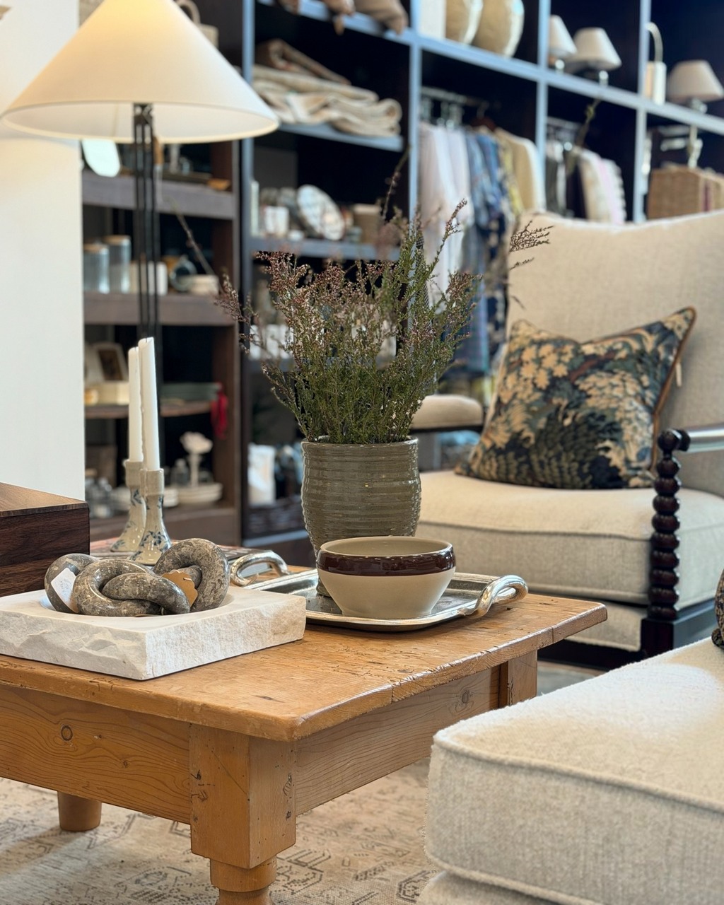 Homestyle Collective silver metal hotel tray styled on a wooden coffee table with a ceramic bowl and dried flowers.