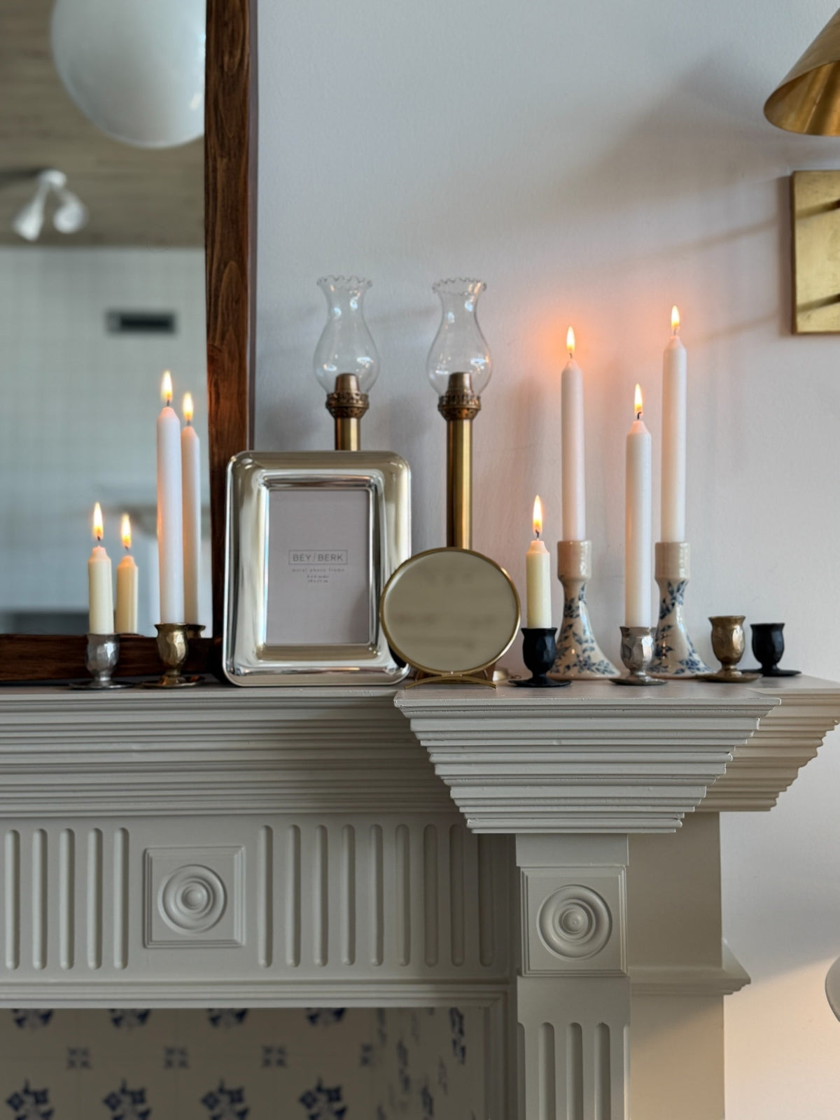 Homestyle Collective silver-plated 4x6 picture frame displayed on a mantelpiece with lit candles.
