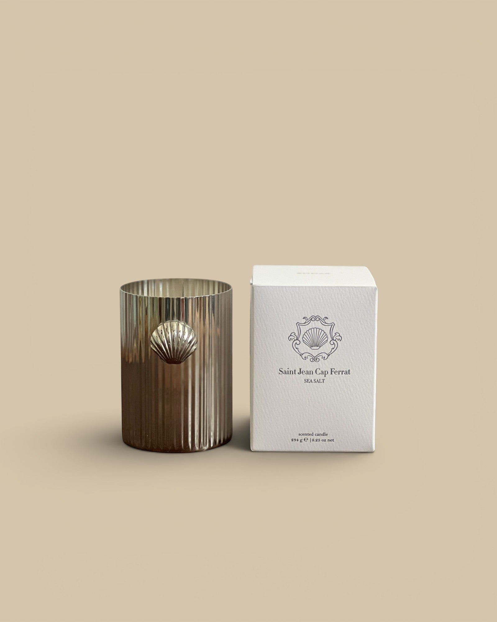 Homestyle Collective silver shell candle with sea salt fragrance. Fluted metal vessel with shell accent.