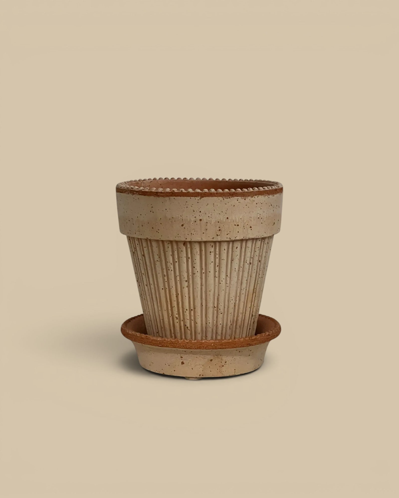 Homestyle Collective Simona pot and saucer in raw rosa terracotta with ribbed texture and beaded rim.