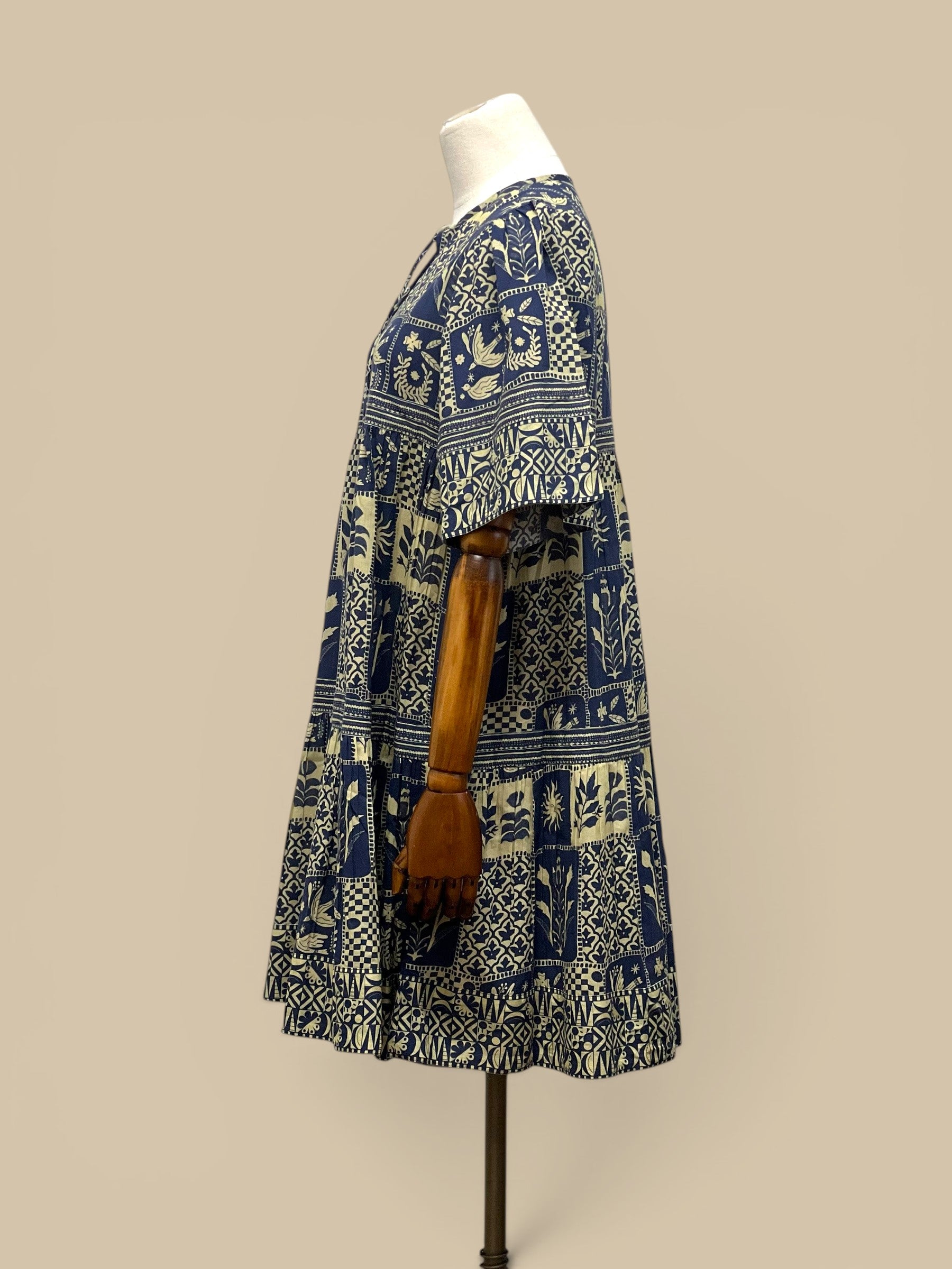 Homestyle Collective Sohana Patches Dress, navy blue and cream 100% cotton, short-sleeve tiered mini dress with tie neck and block print.