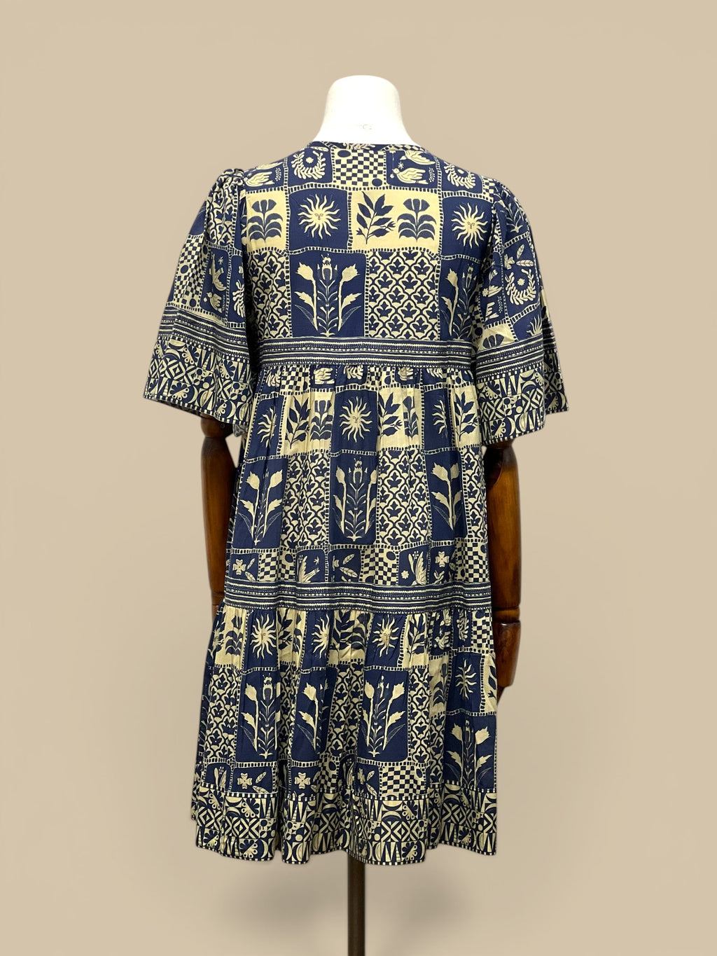 Homestyle Collective Sohana Patches Dress, a navy and cream 100% cotton tiered midi dress with block print floral and sun motifs.