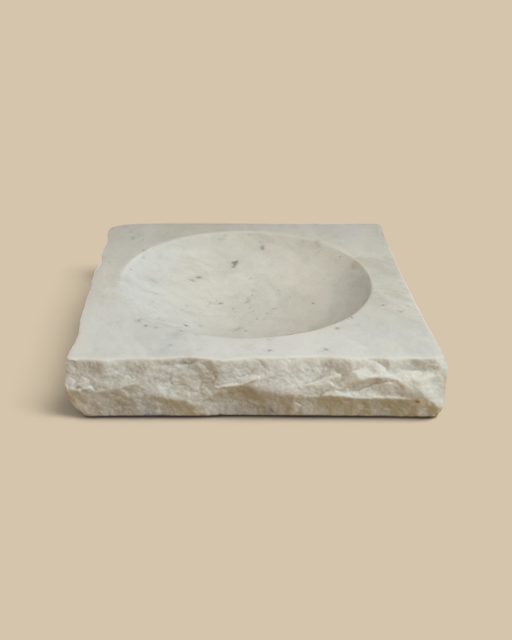 Homestyle Collective square marble bowl with a smooth interior and raw rock-finish edges on a rustic wooden surface.