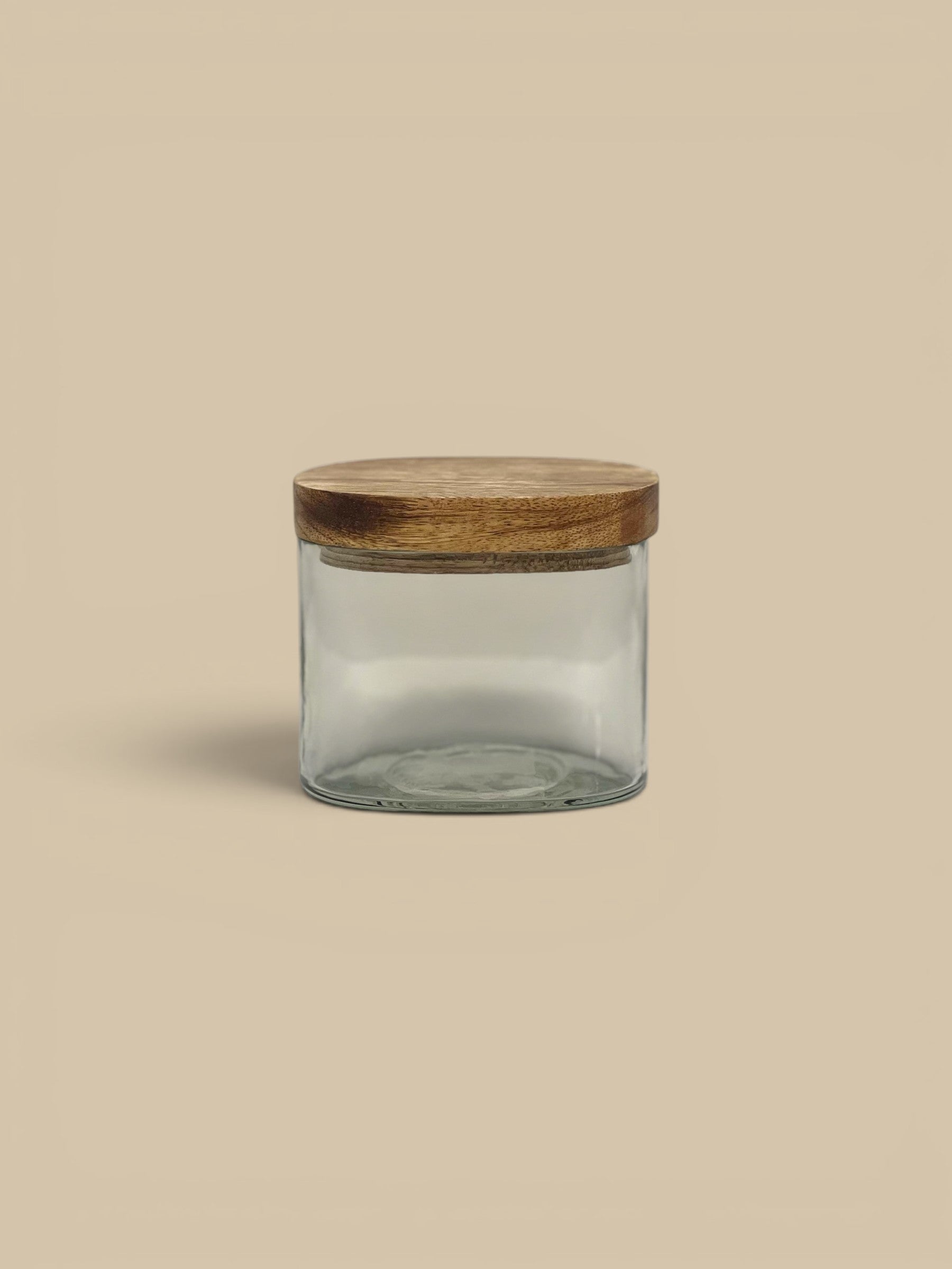 Homestyle Collective Stillwood glass storage jar with a natural wood lid, perfect for pantry or countertop organization.