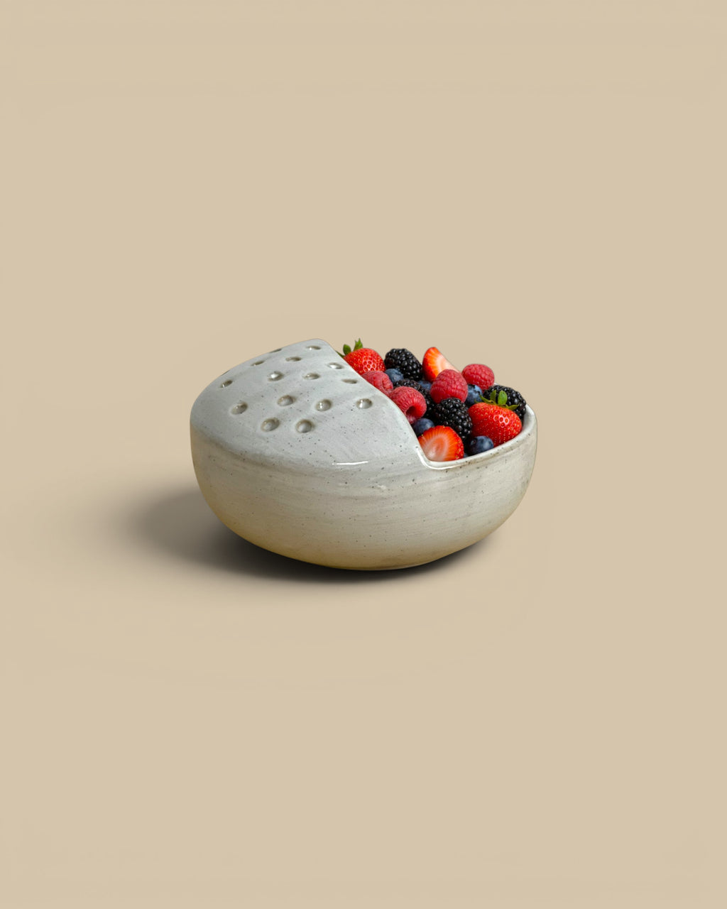 Homestyle Collective stoneware Harvest Rinse Bowl in off-white with a perforated draining section for produce.