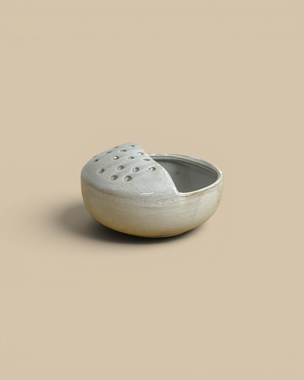 Homestyle Collective stoneware harvest rinse bowl with a perforated draining section in a rustic grey finish.