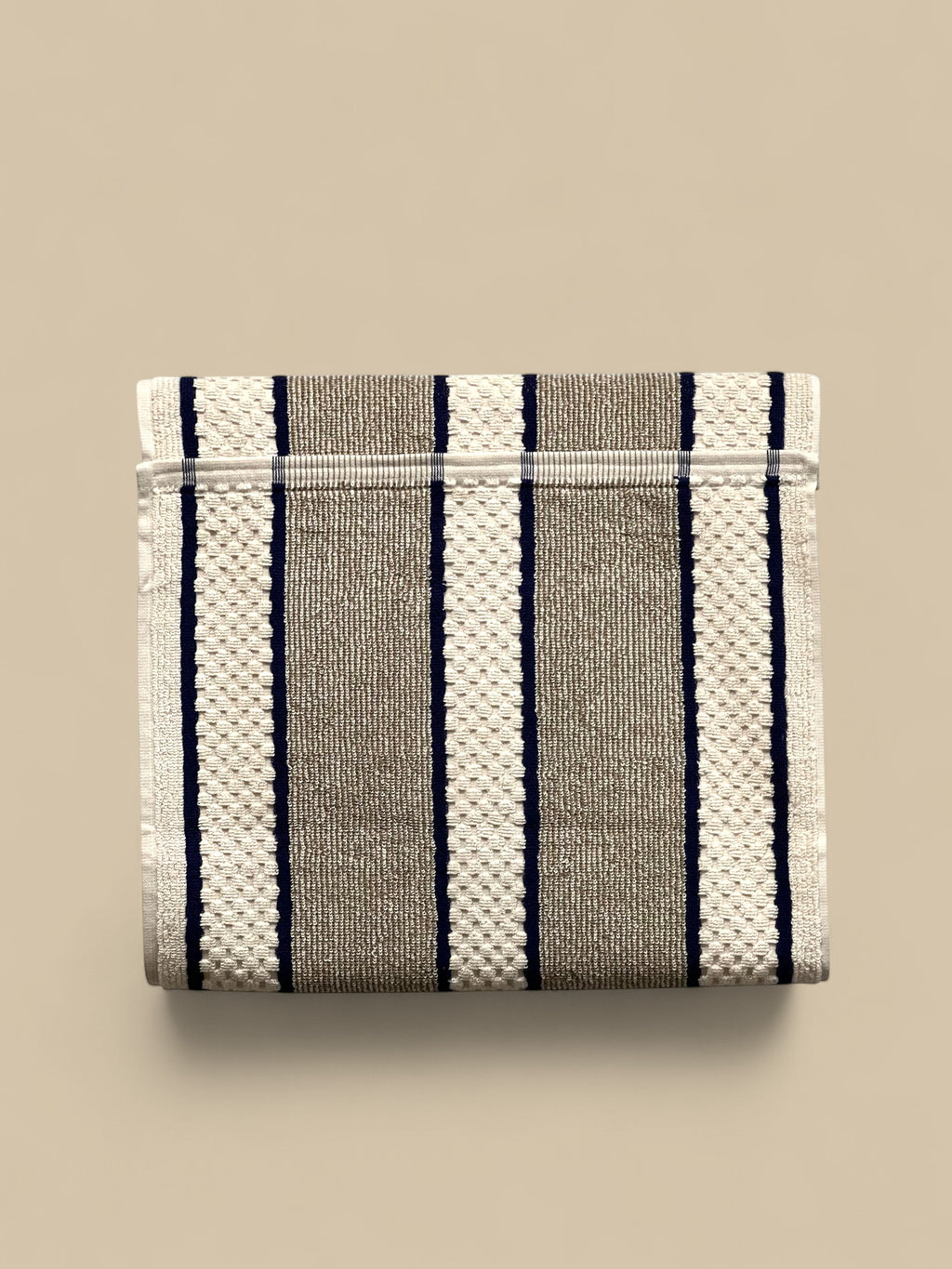 Homestyle Collective grey and white striped 100% cotton range towel with popper fastening for hanging.