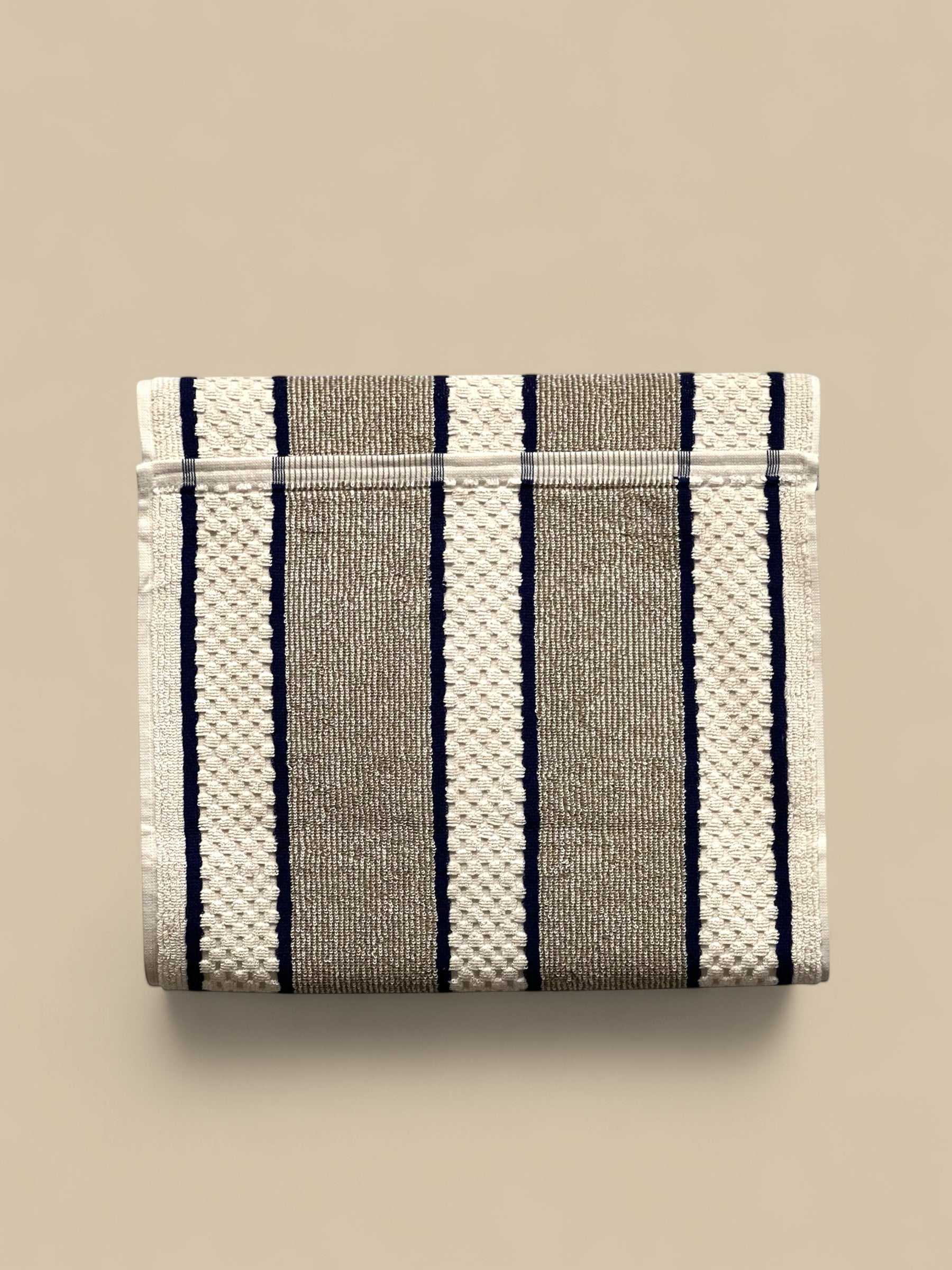 Homestyle Collective grey and white striped 100% cotton range towel with popper fastening for hanging.