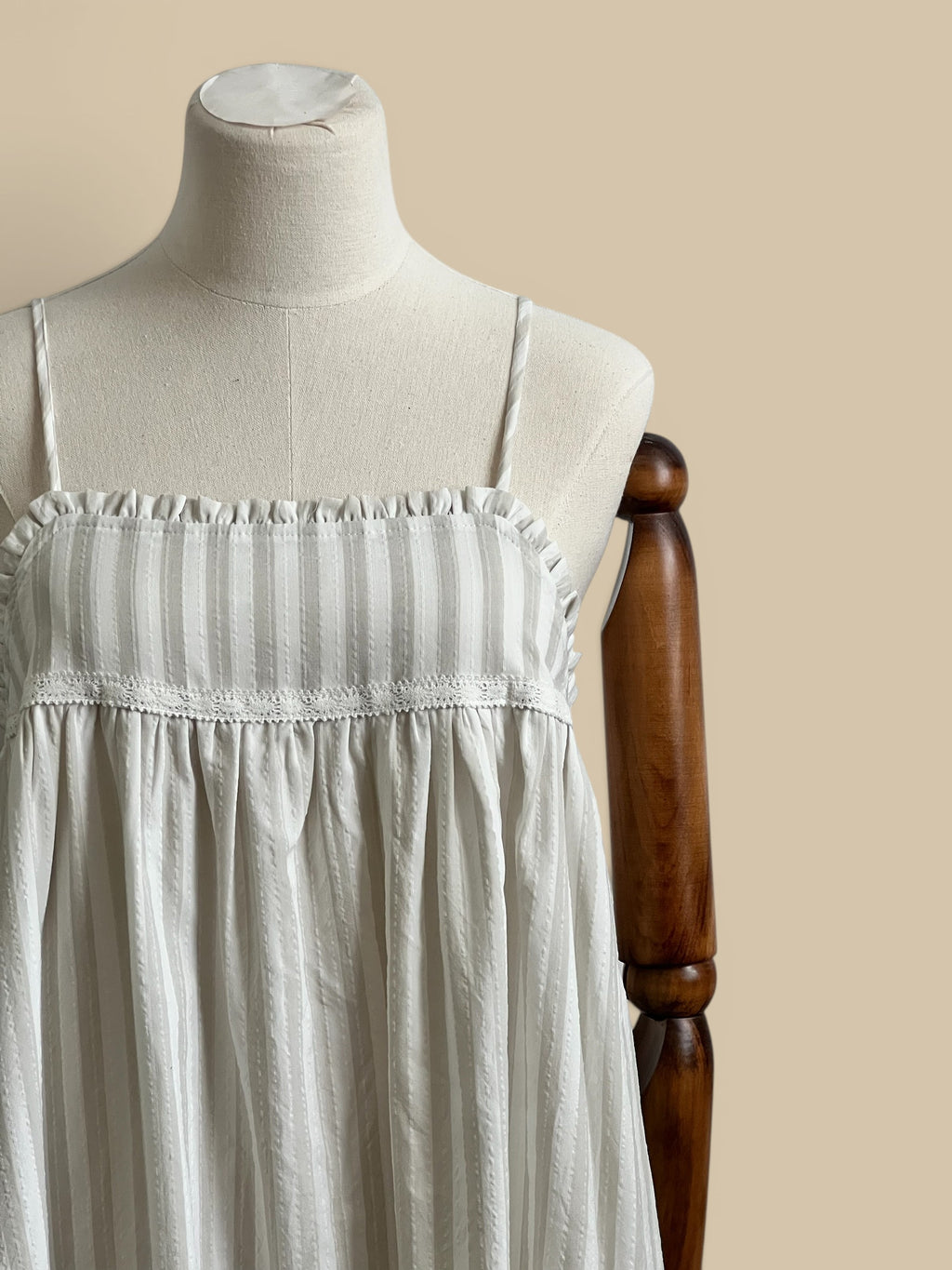 Homestyle Collective beige and white striped rayon-polyester blend dress with embroidered detail and ruffled neckline.