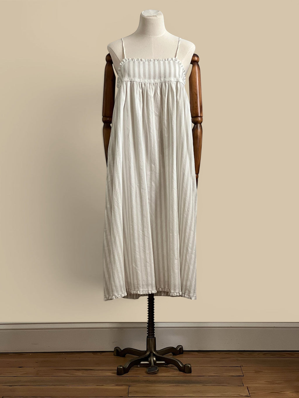 Homestyle Collective beige and white striped rayon-polyester blend midi dress with spaghetti straps and ruffled hem.
