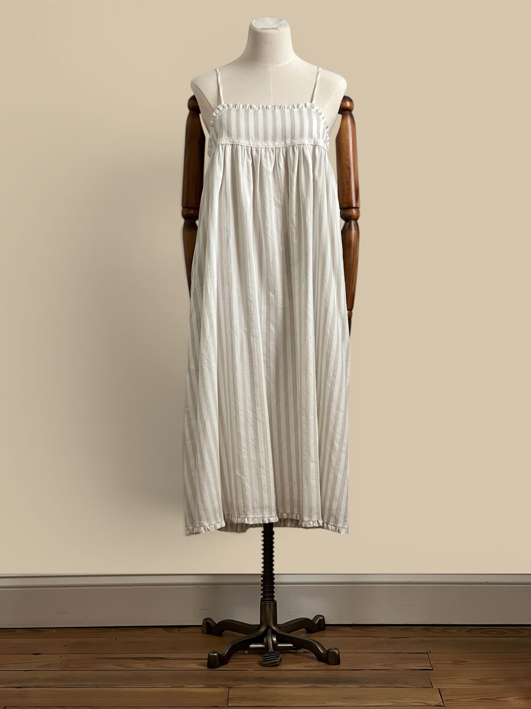 Homestyle Collective beige and white striped rayon-polyester blend midi dress with spaghetti straps and ruffled hem.