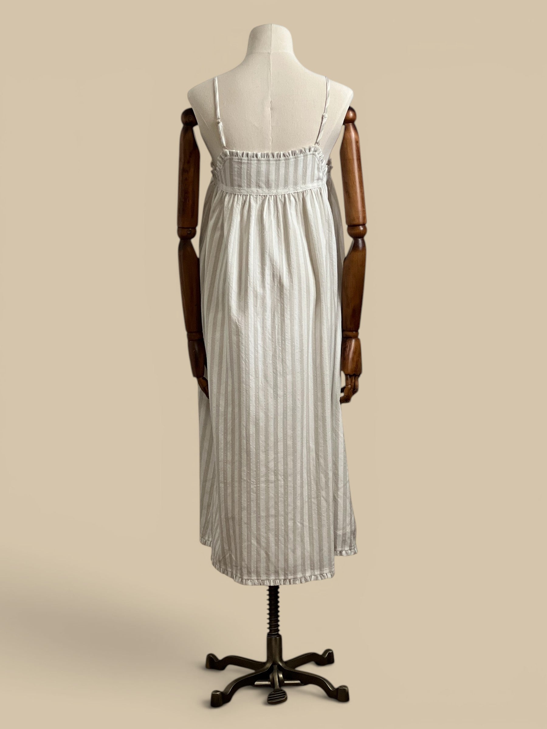Homestyle Collective beige and white striped midi dress with embroidered detail and ruffled neckline. Rayon and polyester blend.