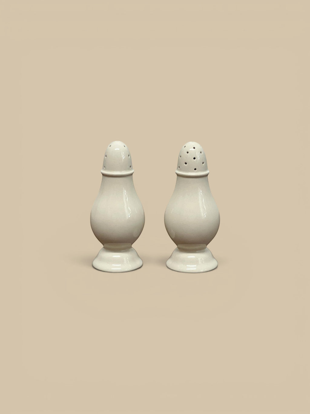 Homestyle Collective Surrey cream stoneware salt and pepper shakers, set of 2, with classic pedestal base and domed tops.