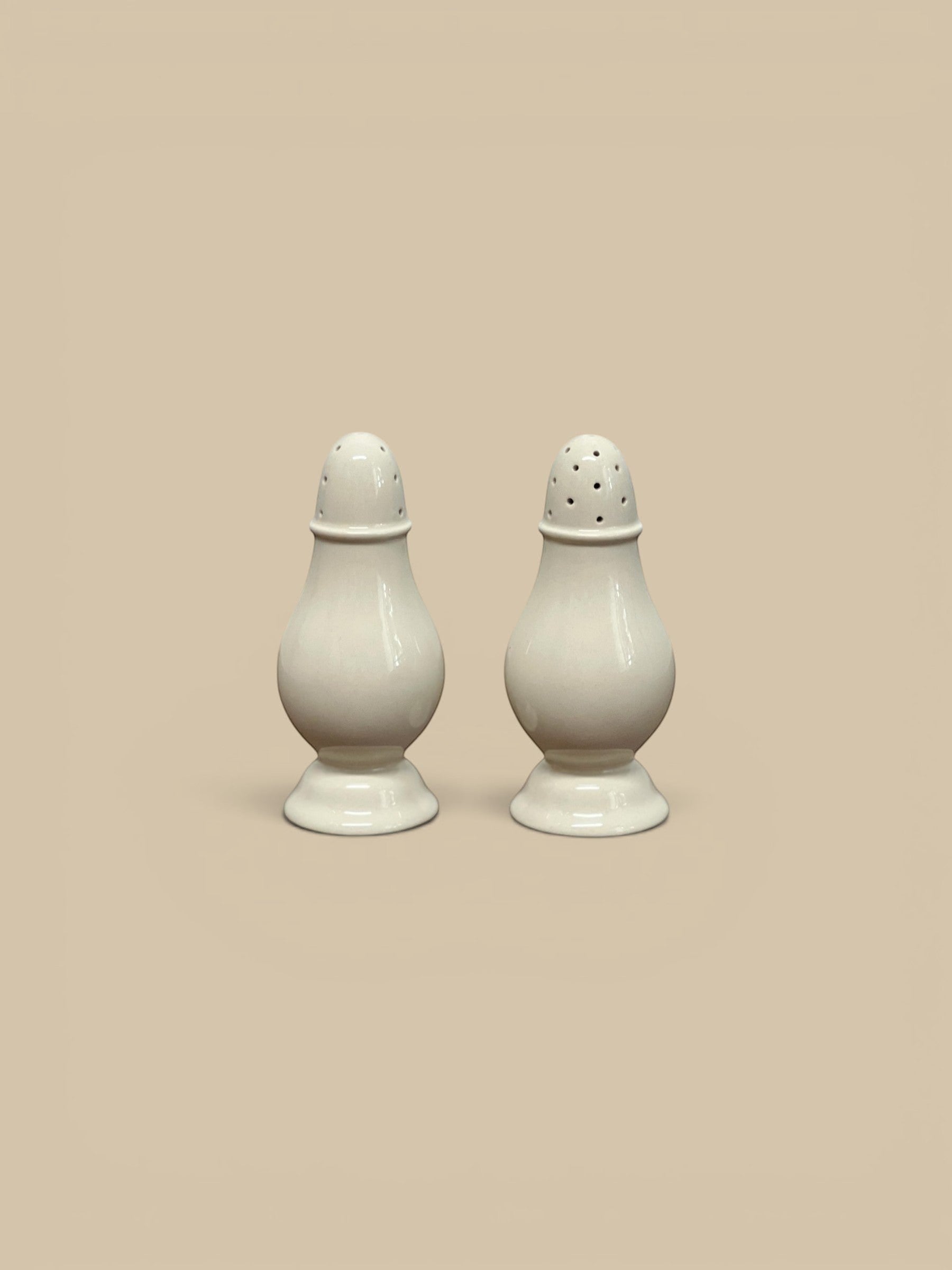 Homestyle Collective Surrey cream stoneware salt and pepper shakers, set of 2, with classic pedestal base and domed tops.