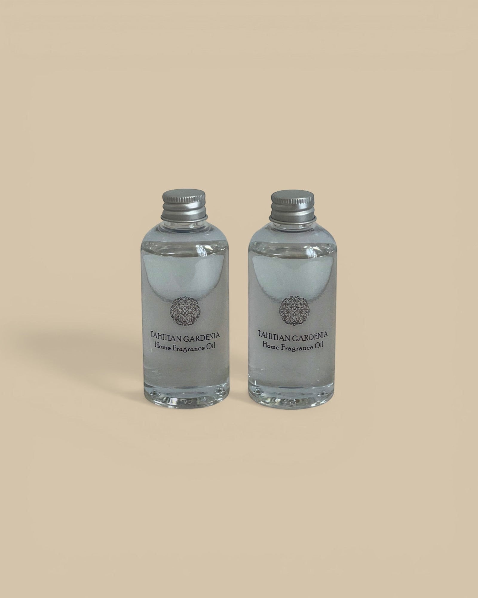 Homestyle Collective Grand Casablanca Porcelain Diffuser Tahitian Gardenia home fragrance oil in clear glass bottles with silver caps.