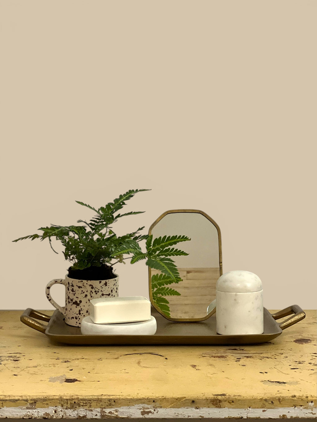 Homestyle Collective Vadara Easel Mirror with textured brass frame and beveled glass, perfect for vanities and shelves.