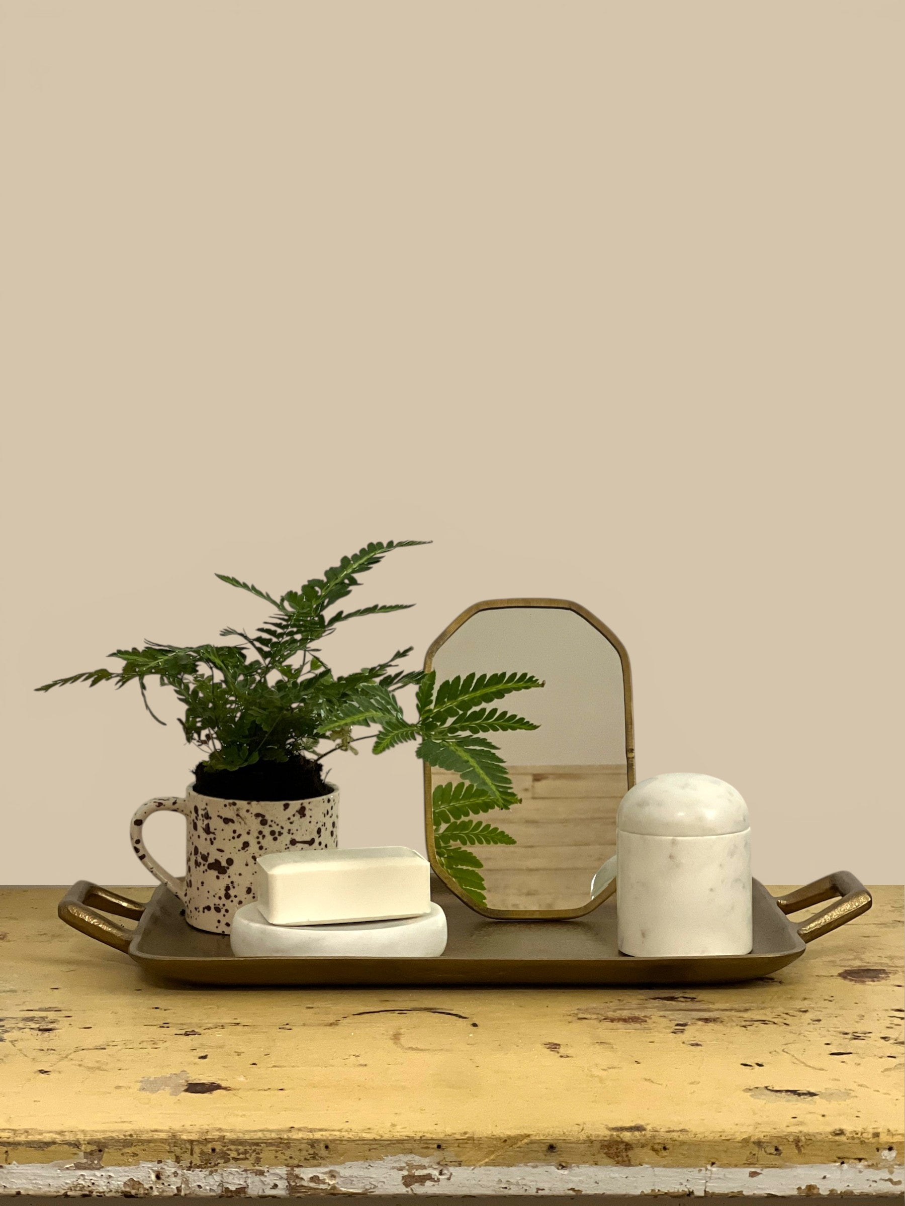 Homestyle Collective Vadara Easel Mirror with textured brass frame and beveled glass, perfect for vanities and shelves.