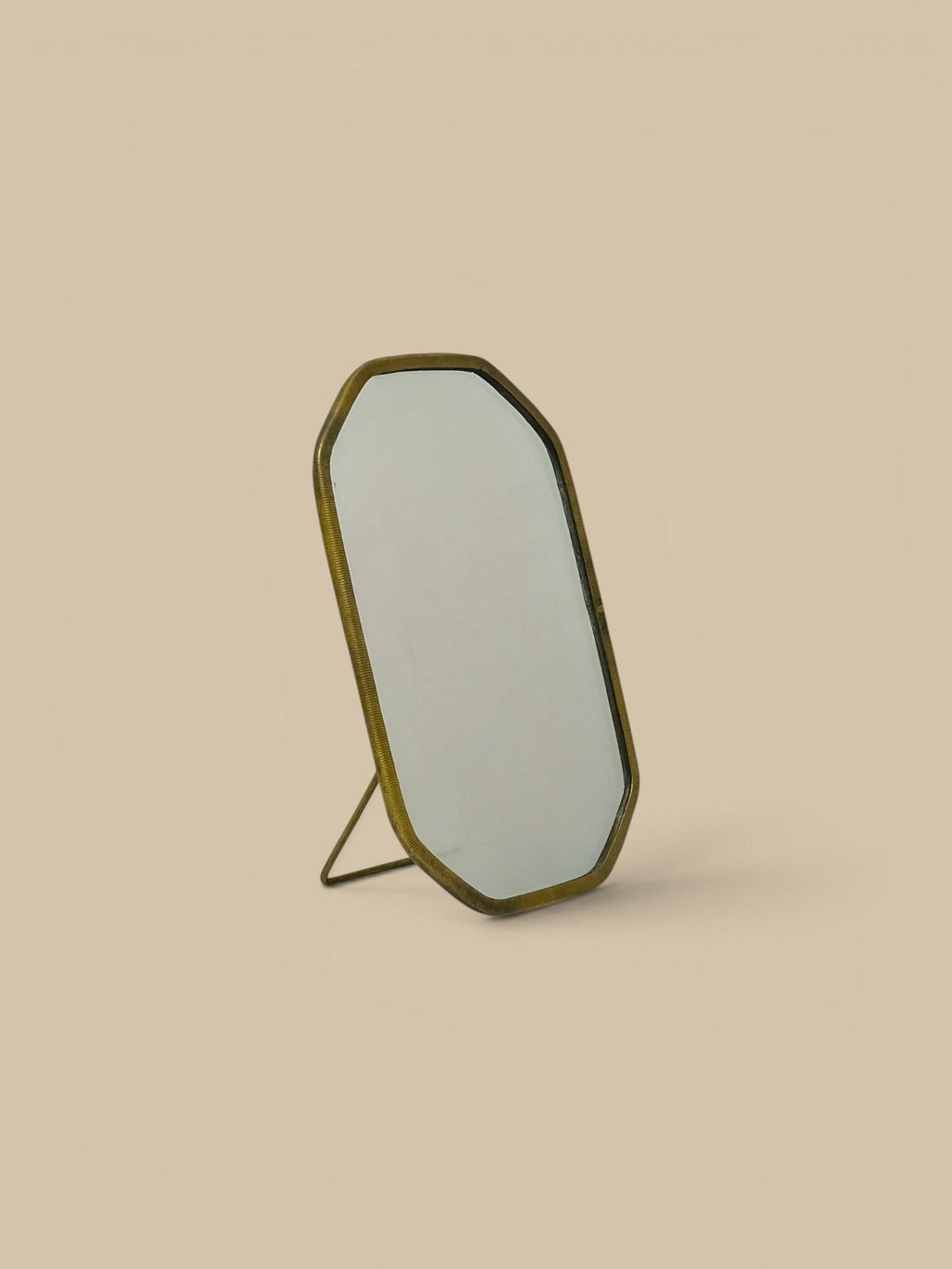 Homestyle Collective Vadara Easel Mirror with textured brass frame and beveled glass. Perfect for vanities or shelves.
