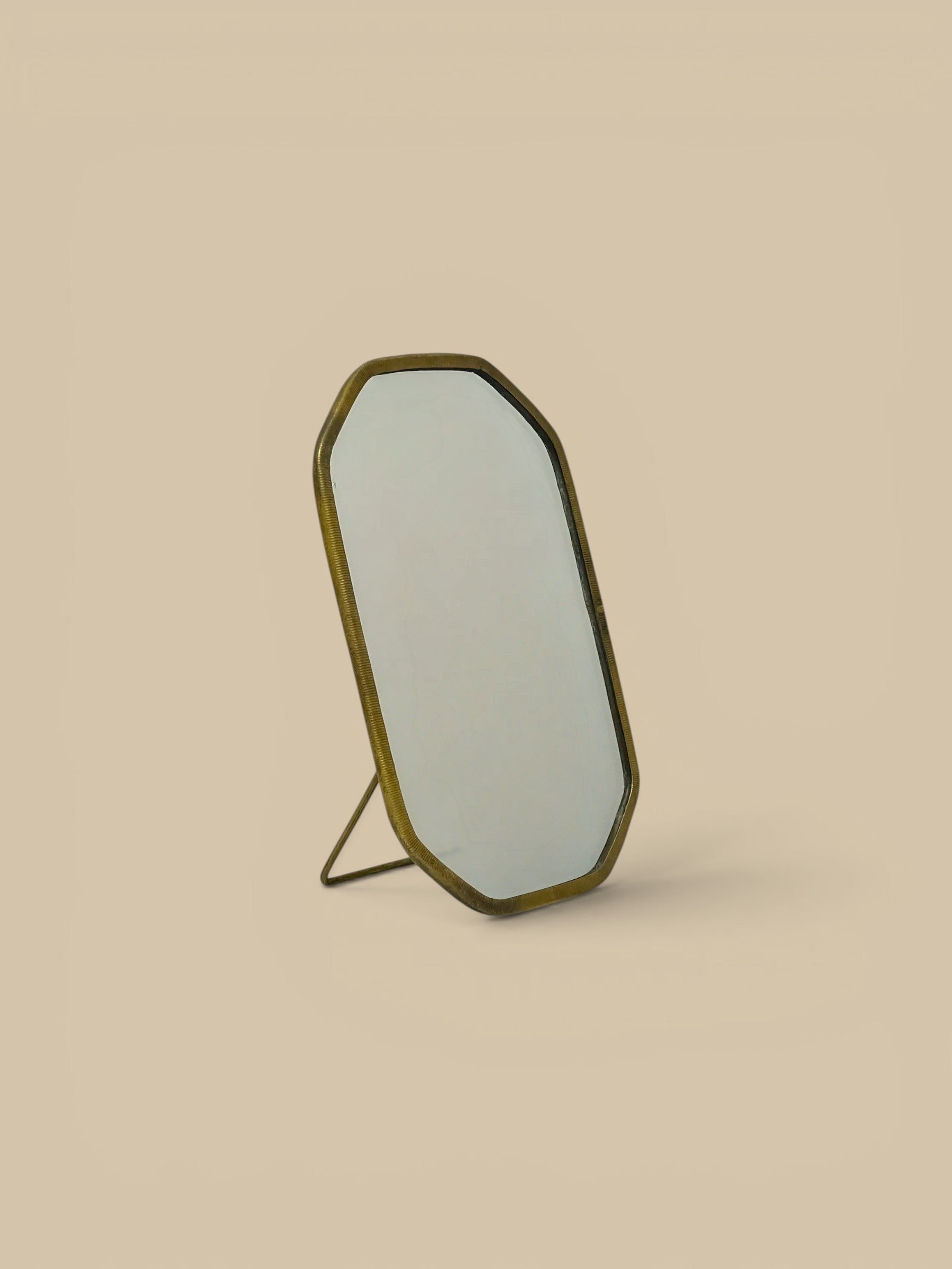 Homestyle Collective Vadara Easel Mirror with textured brass frame and beveled glass. Perfect for vanities or shelves.