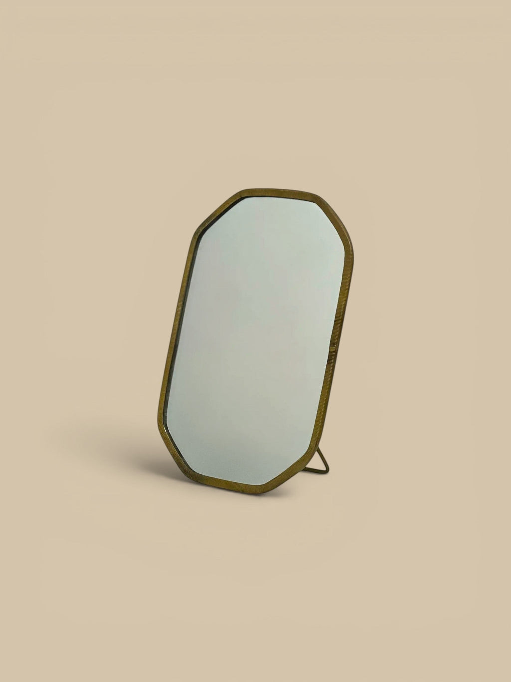 Homestyle Collective Vadara Easel Mirror with textured brass frame and beveled glass, perfect for vanities and shelves.