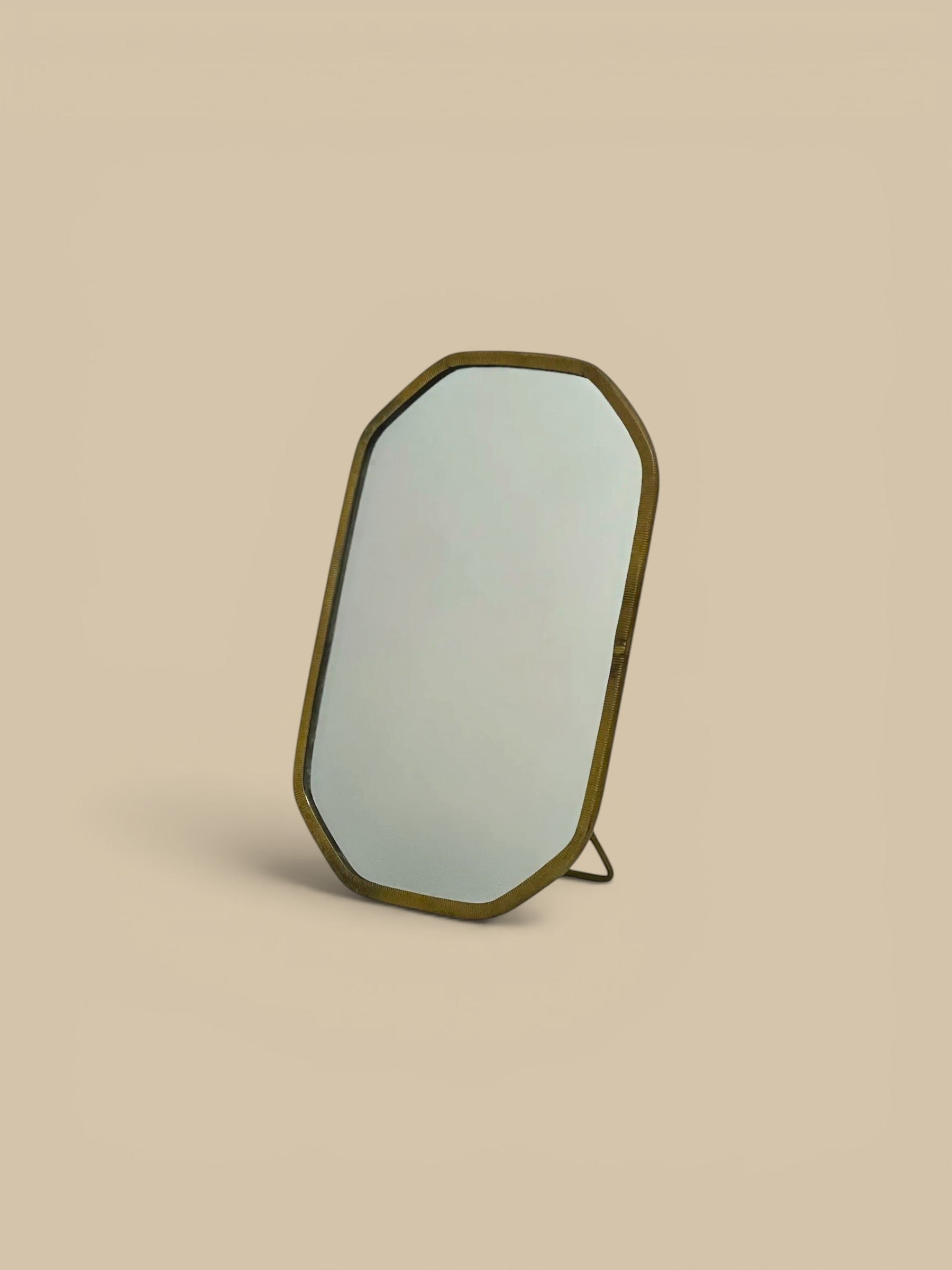 Homestyle Collective Vadara Easel Mirror with textured brass frame and beveled glass, perfect for vanities and shelves.