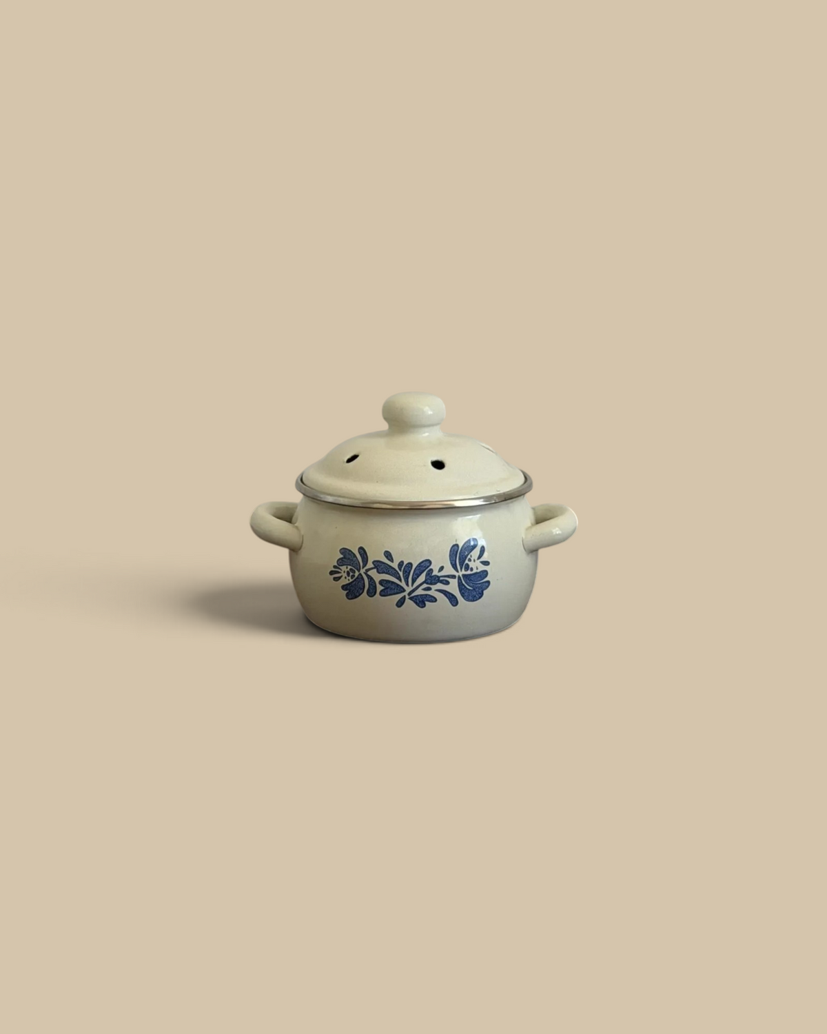 Homestyle Collective vintage blue and cream enamel simmer pot with floral pattern and vented lid on wooden surface