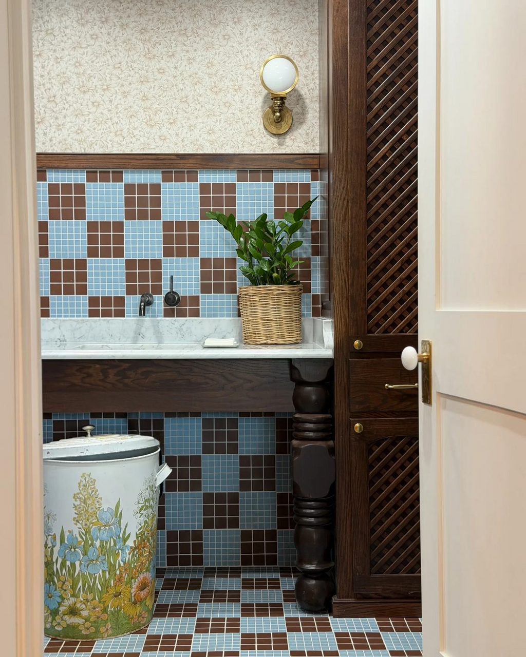 Homestyle Collective vintage 20-gallon metal garbage can with retro floral print in a tiled bathroom setting