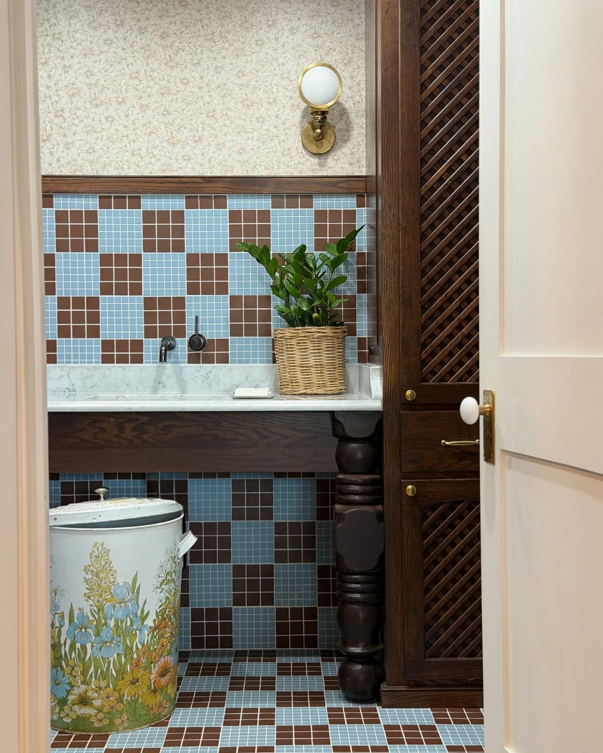 Homestyle Collective vintage 20-gallon metal garbage can with retro floral print in a tiled bathroom setting