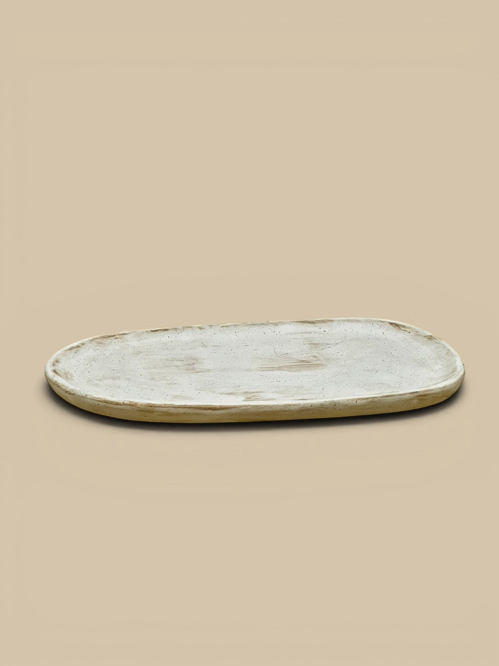 Homestyle Collective Wabi Oval Serving Plate in off-white ceramic with organic form, 10" L x 6.75" W.