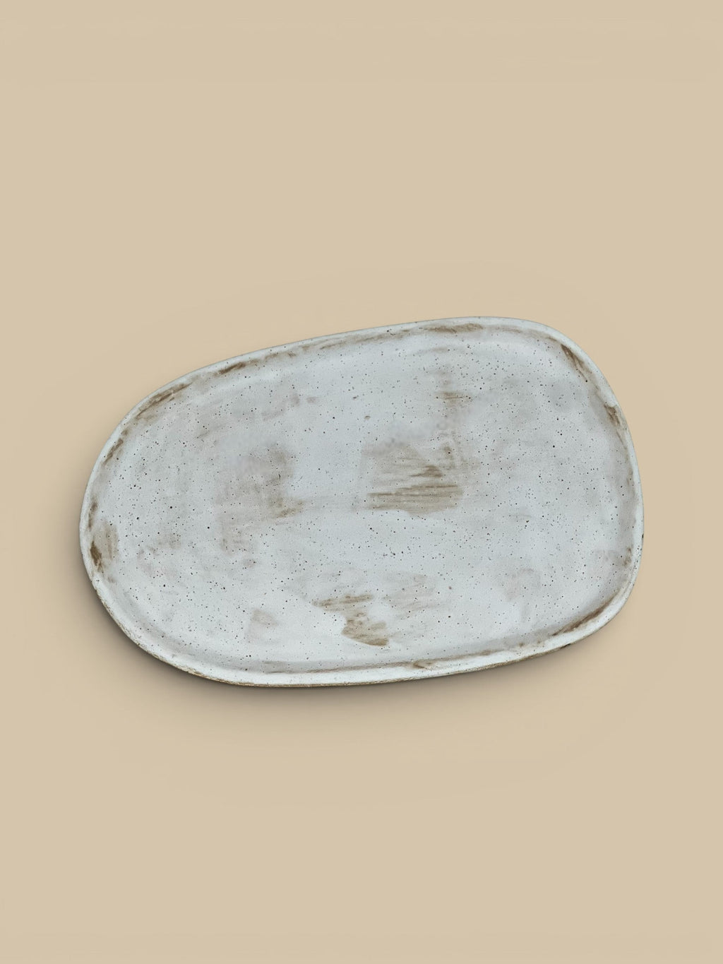 Homestyle Collective Wabi oval serving plate in off-white ceramic with organic form and speckled finish.