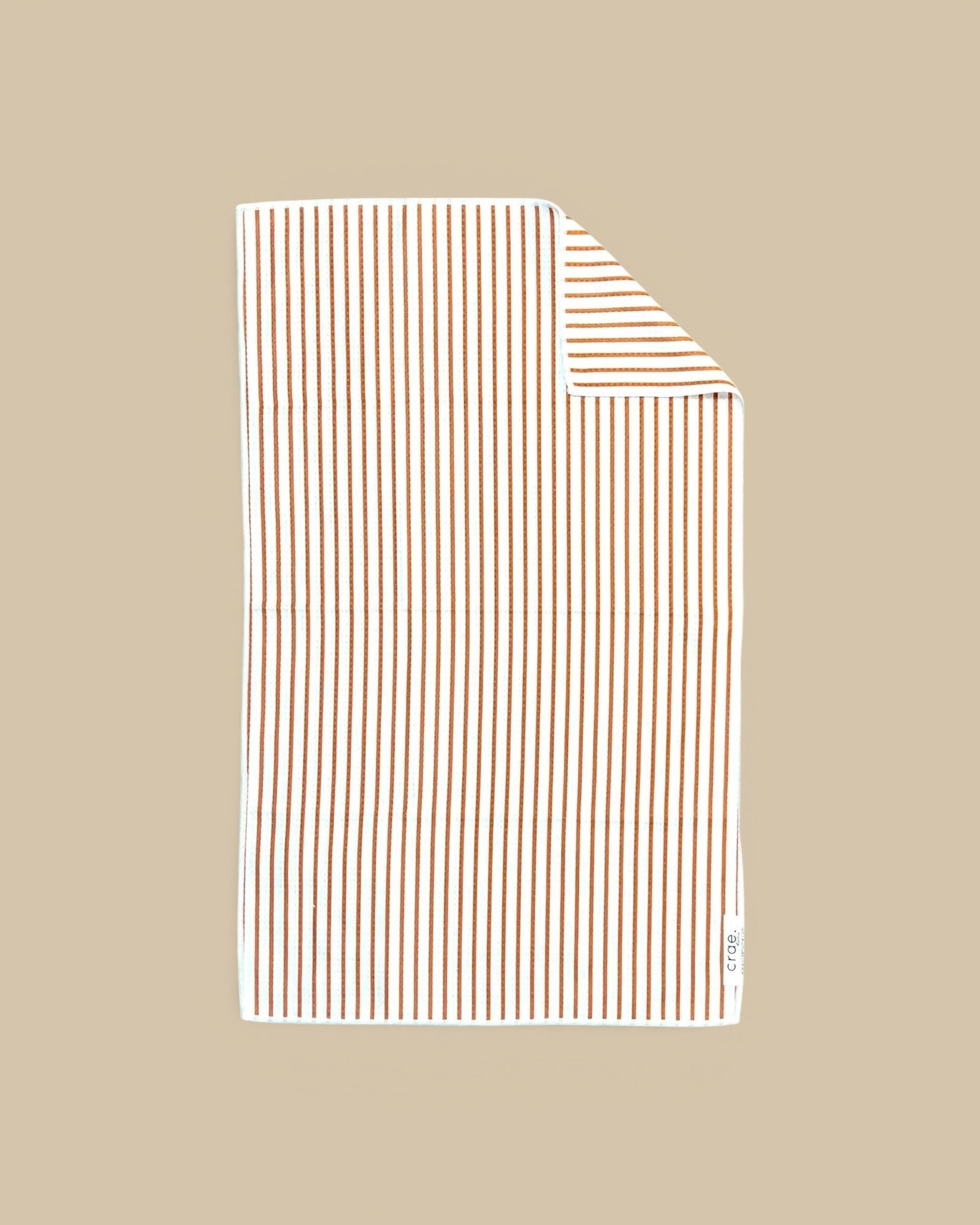 Homestyle Collective white waffle weave hand towel with thin brown vertical stripes