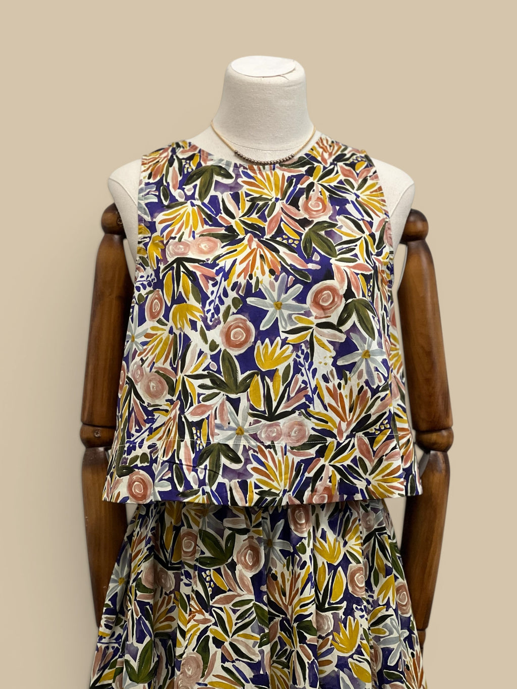 Homestyle Collective watercolor floral sleeveless top with round neckline and relaxed fit. Multi-color botanical print.