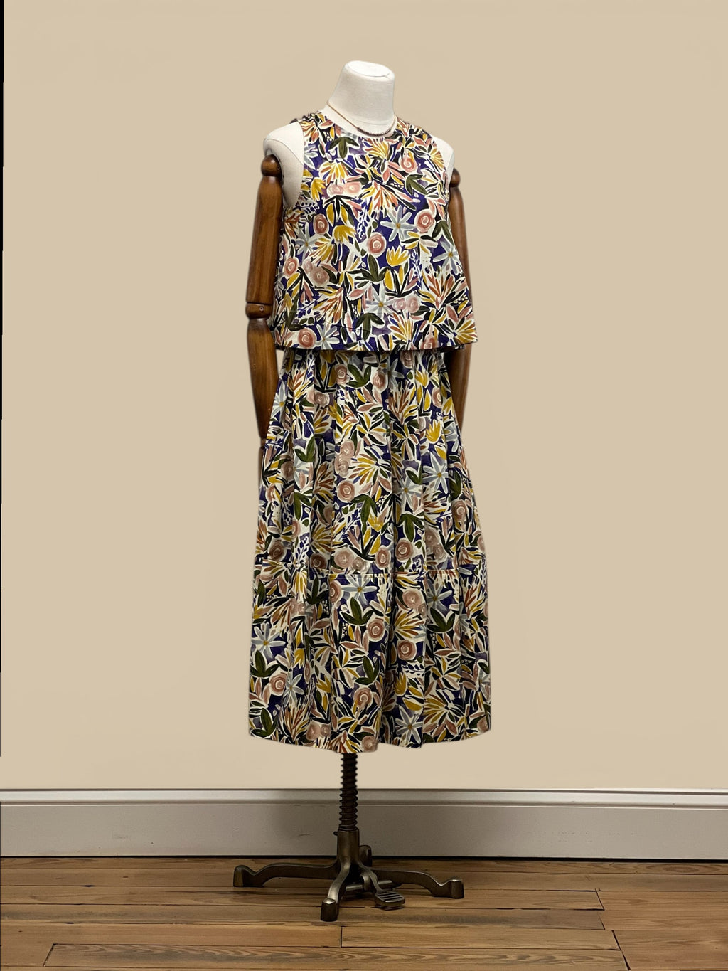 Homestyle Collective watercolor floral sleeveless top with round neckline and relaxed fit. Multi-color botanical print.