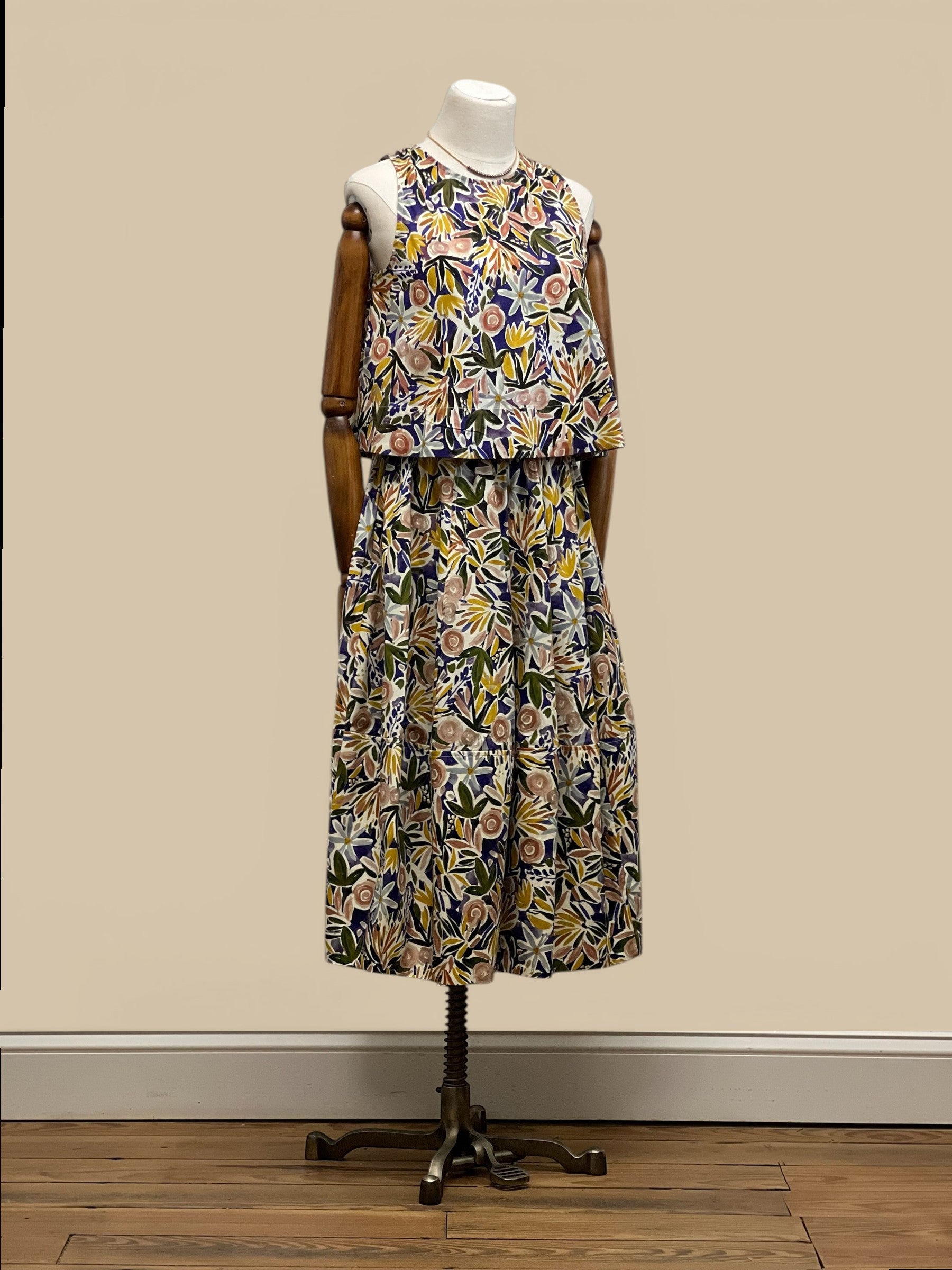 Homestyle Collective watercolor floral sleeveless top with round neckline and relaxed fit. Multi-color botanical print.