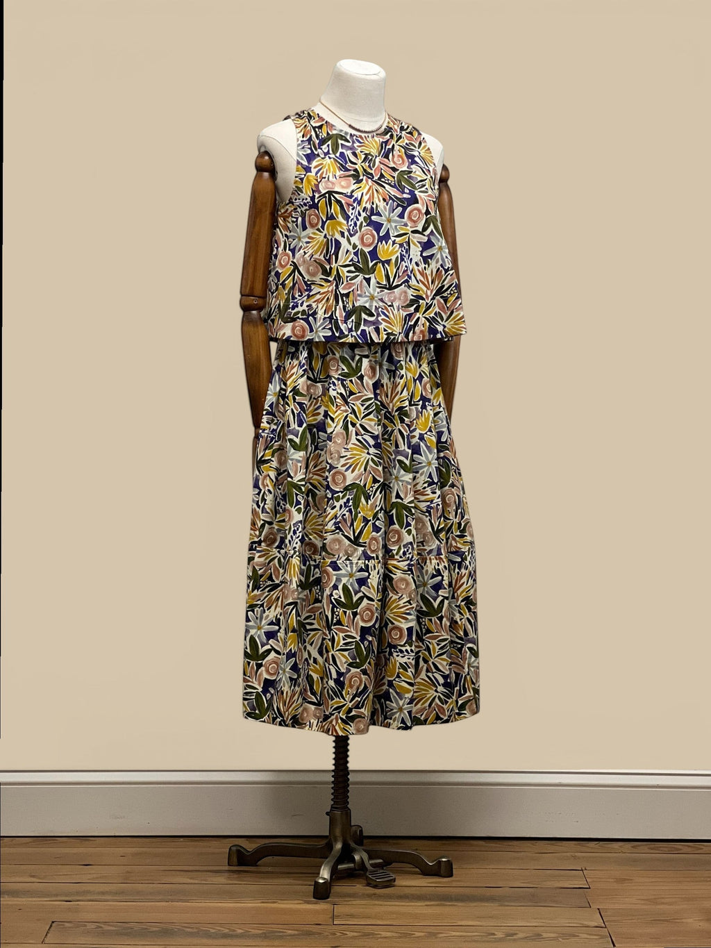 Homestyle Collective watercolor floral sleeveless top with round neckline and relaxed fit. Multi-color botanical print.