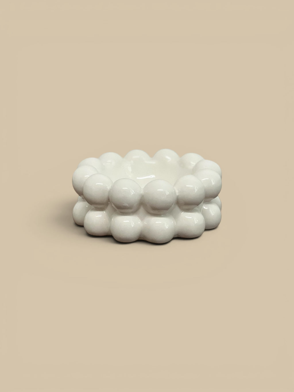 Homestyle Collective white stoneware bowl with raised bubble texture, modern accent piece.