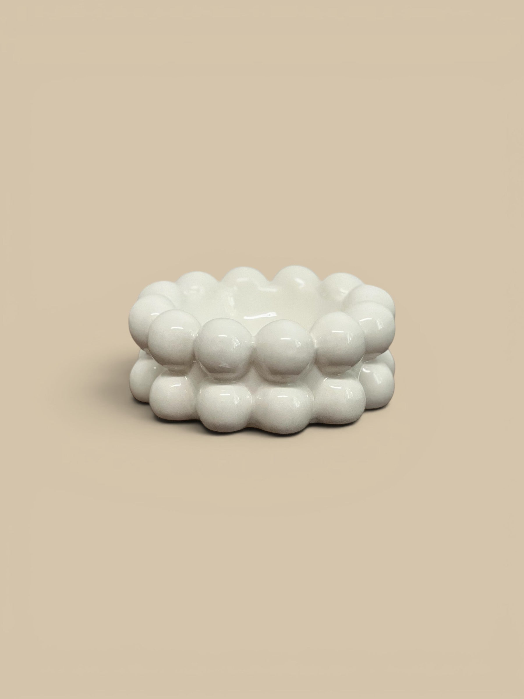 Homestyle Collective white stoneware bowl with raised bubble texture, modern accent piece.