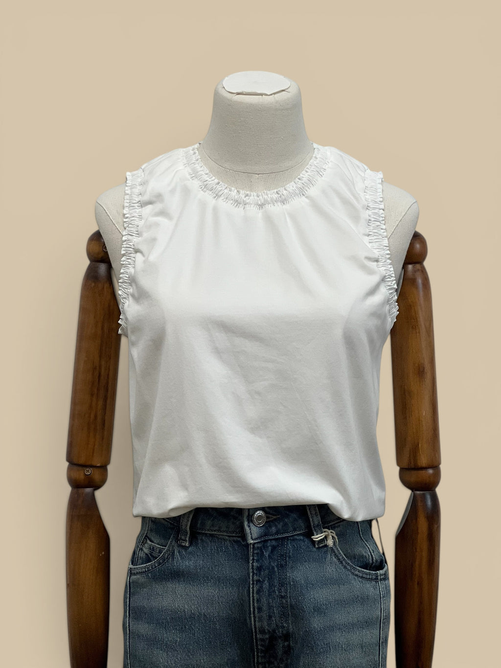 Homestyle Collective white cotton jersey sleeveless top with ruffle detail at neckline and armholes.