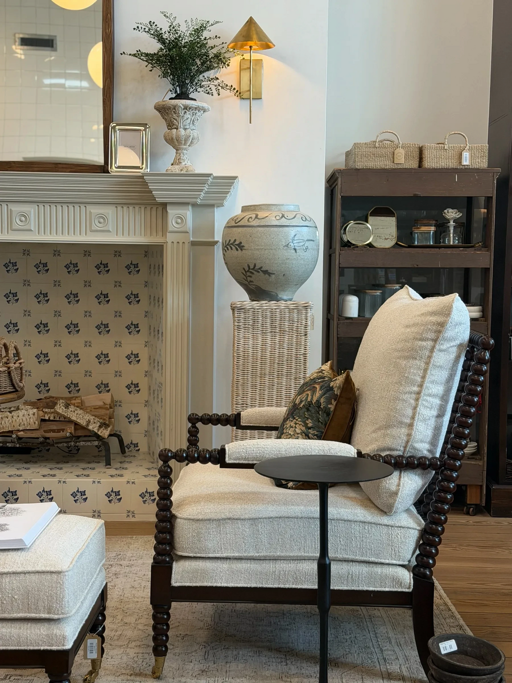 Homestyle Collective vintage white porcelain jar with crackle finish and flying bird design on a wicker pedestal